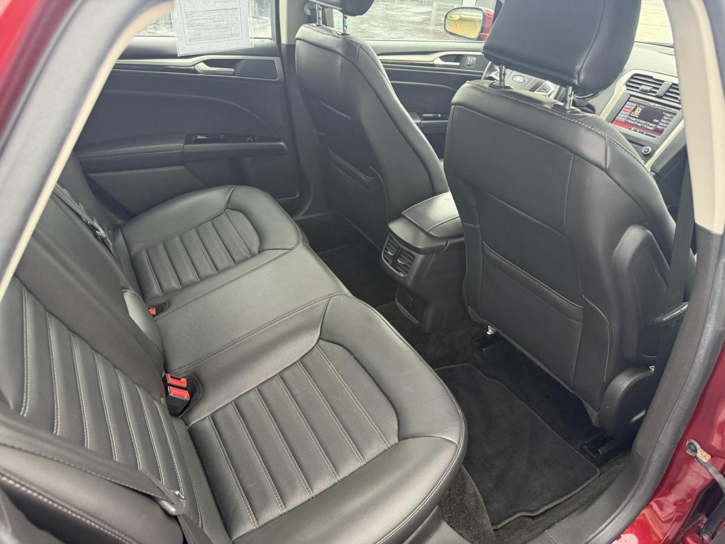 2016 Red /Black Ford Fusion SE AWD (3FA6P0T9XGR) with an 2.0L I4 DOHC 16V Turbo engine, 6A transmission, located at 11115 Chardon Rd. , Chardon, OH, 44024, (440) 214-9705, 41.580246, -81.241943 - This One Owner 2016 Ford Fusion SE AWD features a 2.0L turbocharged I4 engine paired with a 6-speed automatic transmission, offering a quick and fuel-efficient drive with up to 31 MPG highway. It boasts leather interior, heated power driver's seat, dual-zone automatic climate control, power moonroof - Photo#41