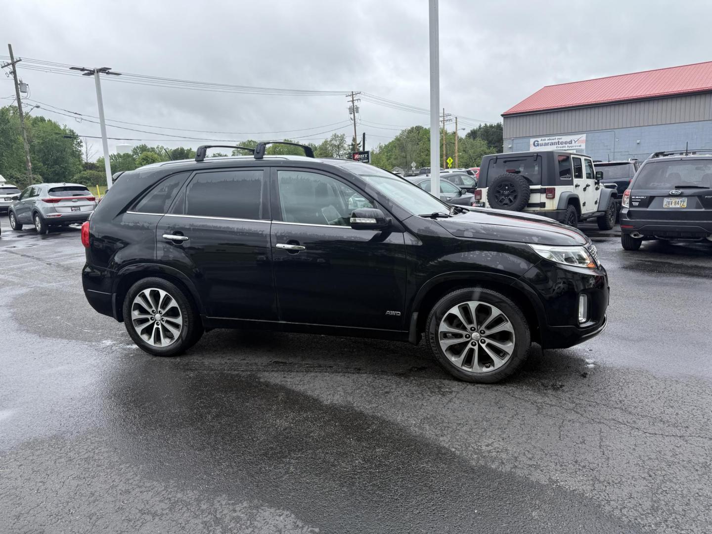 2014 Black /Black Kia Sorento SX V6 AWD (5XYKWDA78EG) with an 3.3L V6 DOHC 24V engine, 6-Speed Automatic transmission, located at 547 E. Main St., Orwell, OH, 44076, (440) 437-5893, 41.535435, -80.847855 - This 2014 Kia Sorento is a fully loaded family hauler. Equipped with Kia's 3.3 GDI V6 and a tried and true 6 speed automatic transmission it can haul 7 people and tow up to 3,500 pounds. On the inside you will find a luxurious leather interior, heated and cooled front seats, a 10 speaker Infinity su - Photo#3