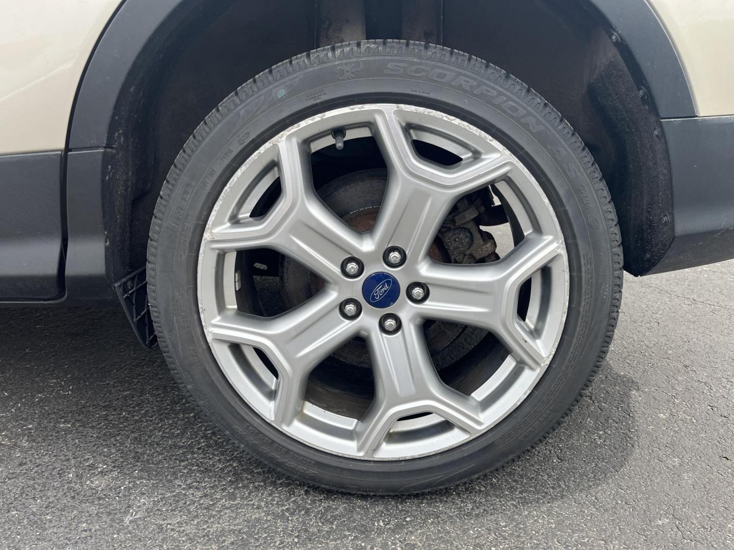 2017 Gold /Gray Ford Escape Titanium 4WD (1FMCU9J96HU) with an 2.0L I4 DOHC 16V Turbo engine, 6A transmission, located at 547 E. Main St., Orwell, OH, 44076, (440) 437-5893, 41.535435, -80.847855 - This One Owner 2017 Ford Escape Titanium is a feature rich compact SUV. Powered by a 2.0 I4 Turbocharged EcoBoost engine and a 6 speed automatic transmission this Escape is quick and fuel efficient achieving an EPA estimated 27 MPG highway. On the inside you get a leather wrapped interior, power fro - Photo#5