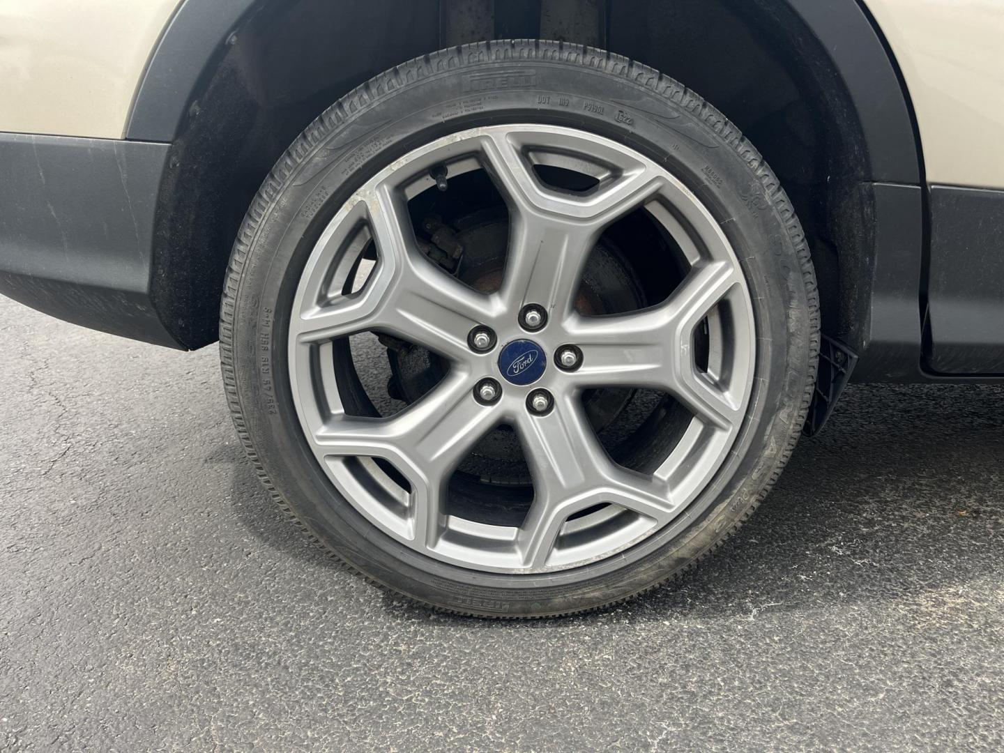 2017 Gold /Gray Ford Escape Titanium 4WD (1FMCU9J96HU) with an 2.0L I4 DOHC 16V Turbo engine, 6A transmission, located at 547 E. Main St., Orwell, OH, 44076, (440) 437-5893, 41.535435, -80.847855 - This One Owner 2017 Ford Escape Titanium is a feature rich compact SUV. Powered by a 2.0 I4 Turbocharged EcoBoost engine and a 6 speed automatic transmission this Escape is quick and fuel efficient achieving an EPA estimated 27 MPG highway. On the inside you get a leather wrapped interior, power fro - Photo#6