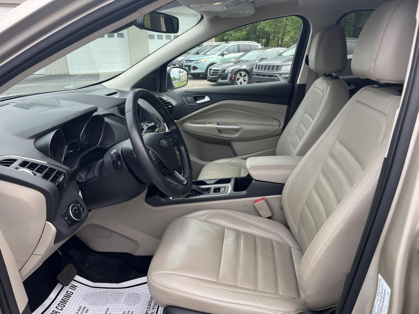 2017 Gold /Gray Ford Escape Titanium 4WD (1FMCU9J96HU) with an 2.0L I4 DOHC 16V Turbo engine, 6A transmission, located at 547 E. Main St., Orwell, OH, 44076, (440) 437-5893, 41.535435, -80.847855 - This One Owner 2017 Ford Escape Titanium is a feature rich compact SUV. Powered by a 2.0 I4 Turbocharged EcoBoost engine and a 6 speed automatic transmission this Escape is quick and fuel efficient achieving an EPA estimated 27 MPG highway. On the inside you get a leather wrapped interior, power fro - Photo#9
