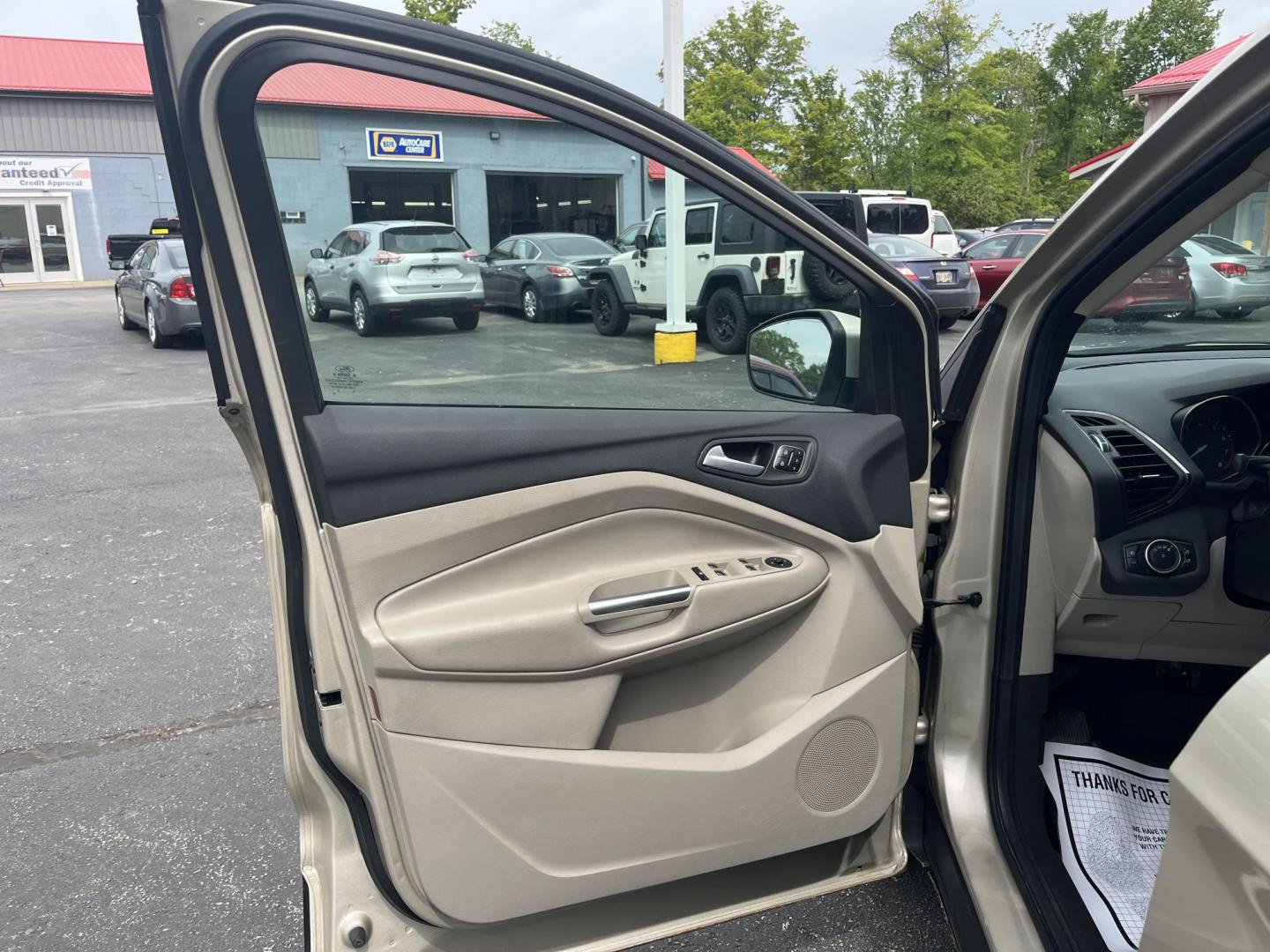 2017 Gold /Gray Ford Escape Titanium 4WD (1FMCU9J96HU) with an 2.0L I4 DOHC 16V Turbo engine, 6A transmission, located at 547 E. Main St., Orwell, OH, 44076, (440) 437-5893, 41.535435, -80.847855 - This One Owner 2017 Ford Escape Titanium is a feature rich compact SUV. Powered by a 2.0 I4 Turbocharged EcoBoost engine and a 6 speed automatic transmission this Escape is quick and fuel efficient achieving an EPA estimated 27 MPG highway. On the inside you get a leather wrapped interior, power fro - Photo#8