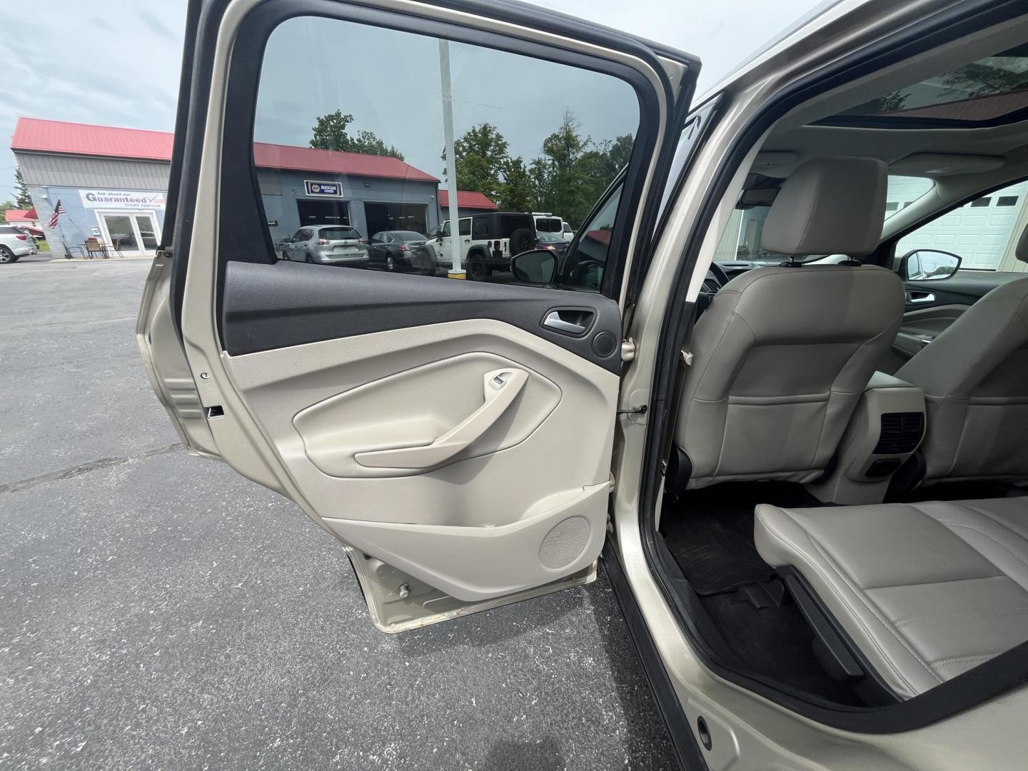 2017 Gold /Gray Ford Escape Titanium 4WD (1FMCU9J96HU) with an 2.0L I4 DOHC 16V Turbo engine, 6A transmission, located at 547 E. Main St., Orwell, OH, 44076, (440) 437-5893, 41.535435, -80.847855 - This One Owner 2017 Ford Escape Titanium is a feature rich compact SUV. Powered by a 2.0 I4 Turbocharged EcoBoost engine and a 6 speed automatic transmission this Escape is quick and fuel efficient achieving an EPA estimated 27 MPG highway. On the inside you get a leather wrapped interior, power fro - Photo#24