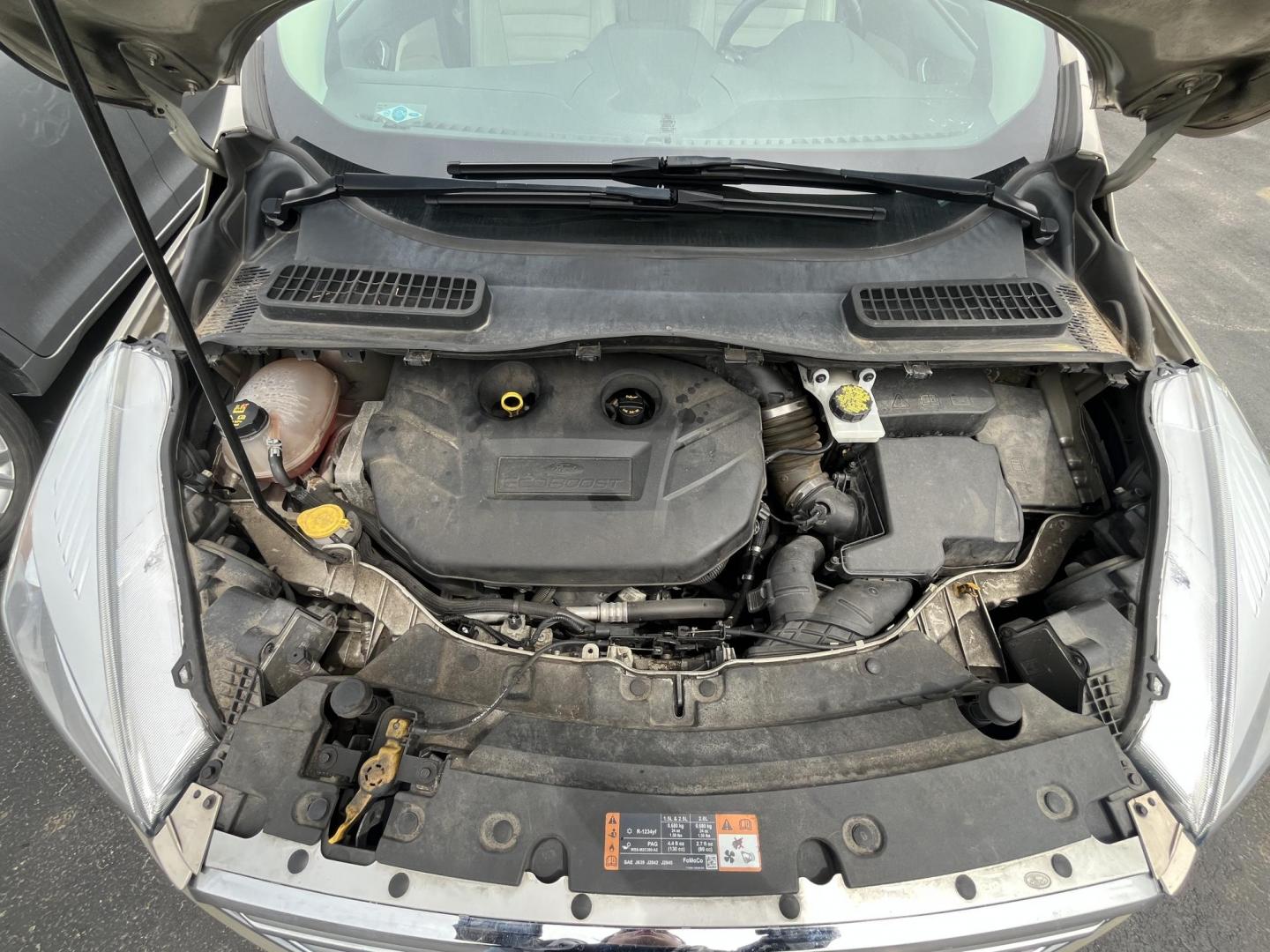 2017 Gold /Gray Ford Escape Titanium 4WD (1FMCU9J96HU) with an 2.0L I4 DOHC 16V Turbo engine, 6A transmission, located at 547 E. Main St., Orwell, OH, 44076, (440) 437-5893, 41.535435, -80.847855 - This One Owner 2017 Ford Escape Titanium is a feature rich compact SUV. Powered by a 2.0 I4 Turbocharged EcoBoost engine and a 6 speed automatic transmission this Escape is quick and fuel efficient achieving an EPA estimated 27 MPG highway. On the inside you get a leather wrapped interior, power fro - Photo#3