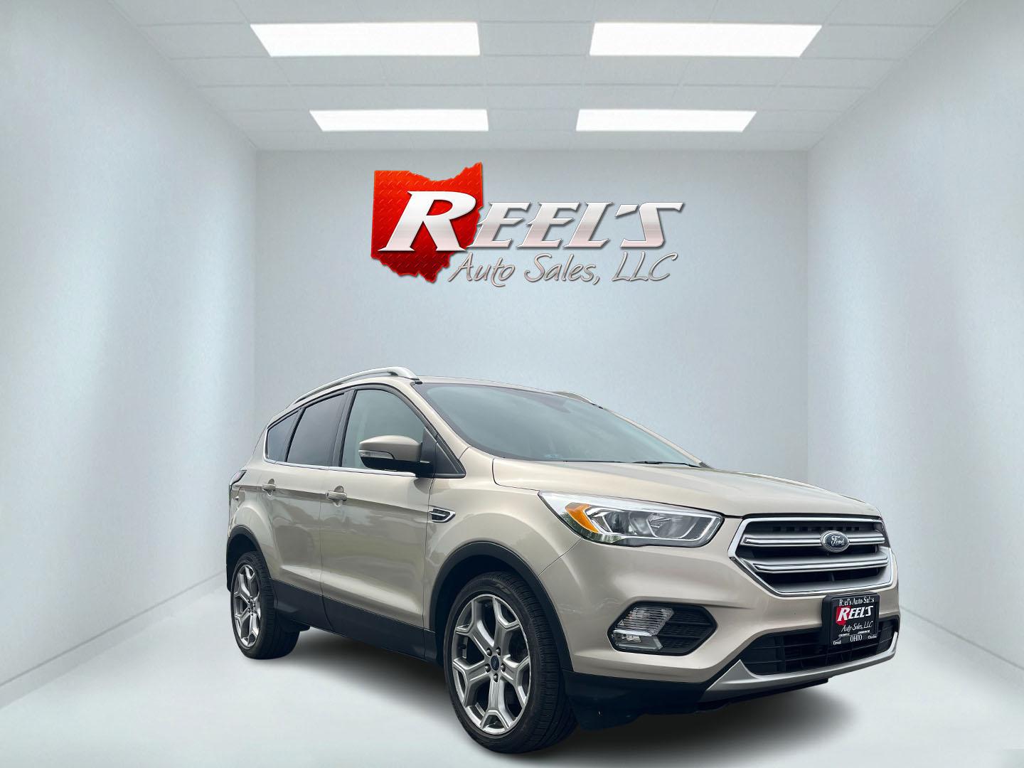 2017 Gold /Gray Ford Escape Titanium 4WD (1FMCU9J96HU) with an 2.0L I4 DOHC 16V Turbo engine, 6A transmission, located at 547 E. Main St., Orwell, OH, 44076, (440) 437-5893, 41.535435, -80.847855 - This One Owner 2017 Ford Escape Titanium is a feature rich compact SUV. Powered by a 2.0 I4 Turbocharged EcoBoost engine and a 6 speed automatic transmission this Escape is quick and fuel efficient achieving an EPA estimated 27 MPG highway. On the inside you get a leather wrapped interior, power fro - Photo#2