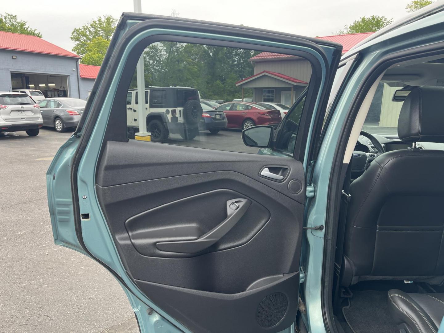 2013 Blue /Black Ford Escape Titanium 4WD (1FMCU9J99DU) with an 2.0L I4 DOHC 16V Turbo engine, 6-Speed Automatic transmission, located at 547 E. Main St., Orwell, OH, 44076, (440) 437-5893, 41.535435, -80.847855 - This 2013 Ford Escape is as loaded as an Escape can be. Powered by a 2.0 I4 Turbocharged EcoBoost engine and a 6 speed automatic transmission this Escape is quick yet fuel efficient. On the Inside you get a leather interior, power drivers seat W/ drivers memory functions, heated front seats and, a d - Photo#29