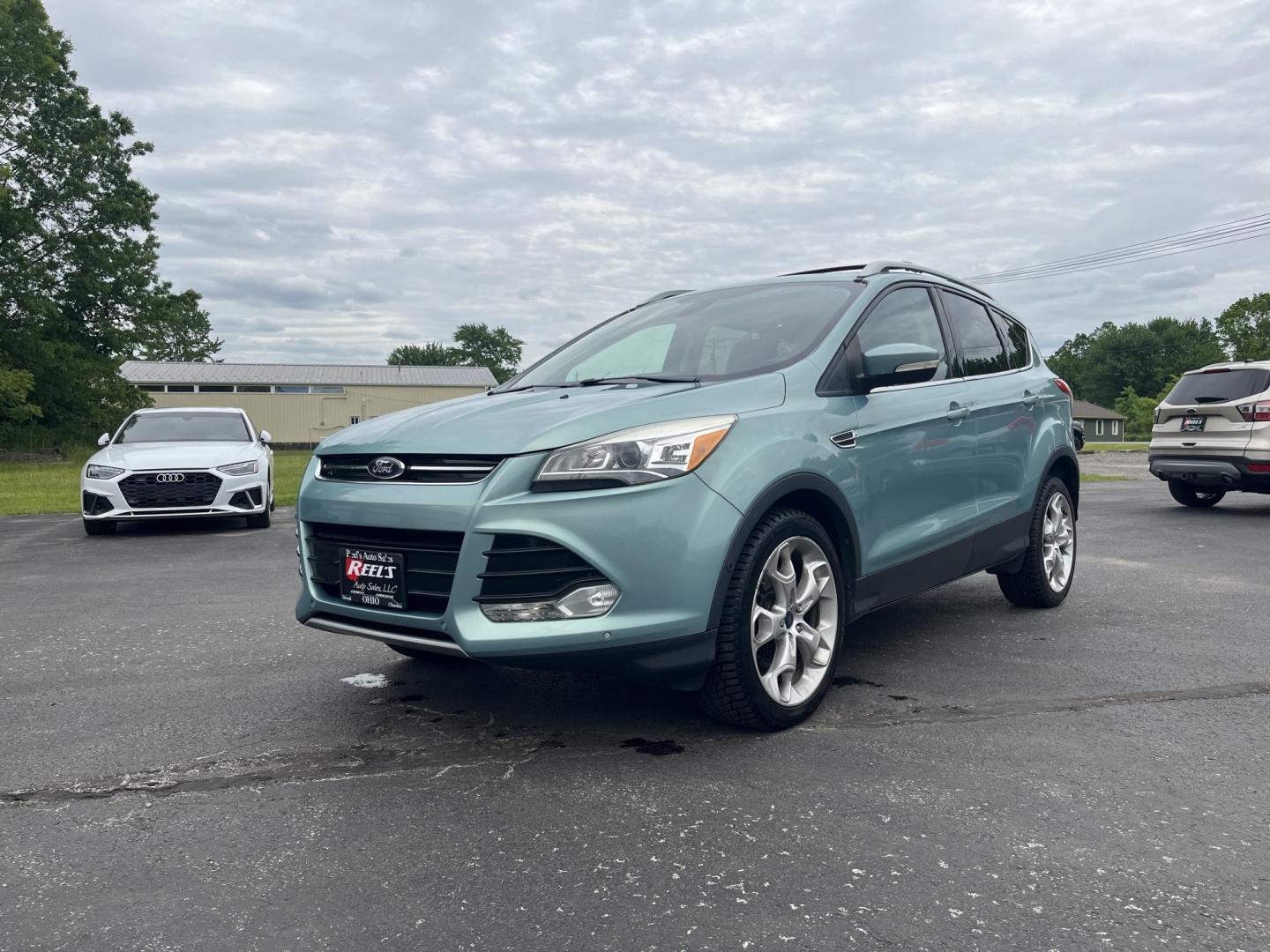 2013 Blue /Black Ford Escape Titanium 4WD (1FMCU9J99DU) with an 2.0L I4 DOHC 16V Turbo engine, 6-Speed Automatic transmission, located at 547 E. Main St., Orwell, OH, 44076, (440) 437-5893, 41.535435, -80.847855 - This 2013 Ford Escape is as loaded as an Escape can be. Powered by a 2.0 I4 Turbocharged EcoBoost engine and a 6 speed automatic transmission this Escape is quick yet fuel efficient. On the Inside you get a leather interior, power drivers seat W/ drivers memory functions, heated front seats and, a d - Photo#0