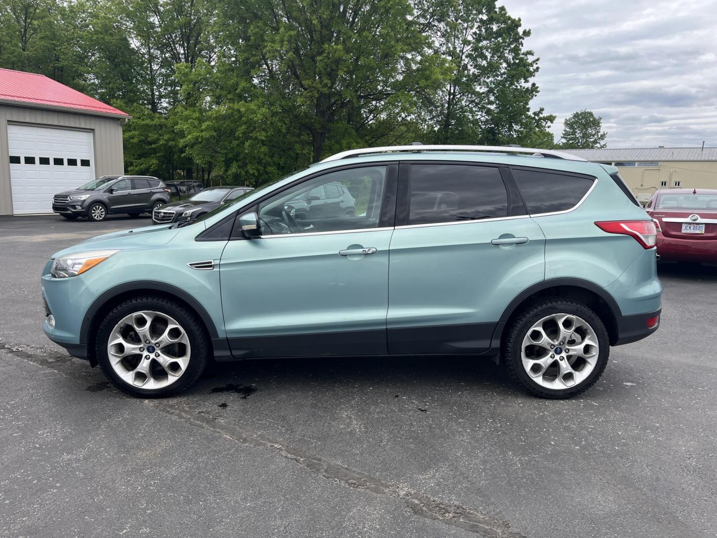 2013 Blue /Black Ford Escape Titanium 4WD (1FMCU9J99DU) with an 2.0L I4 DOHC 16V Turbo engine, 6-Speed Automatic transmission, located at 547 E. Main St., Orwell, OH, 44076, (440) 437-5893, 41.535435, -80.847855 - This 2013 Ford Escape is as loaded as an Escape can be. Powered by a 2.0 I4 Turbocharged EcoBoost engine and a 6 speed automatic transmission this Escape is quick yet fuel efficient. On the Inside you get a leather interior, power drivers seat W/ drivers memory functions, heated front seats and, a d - Photo#9