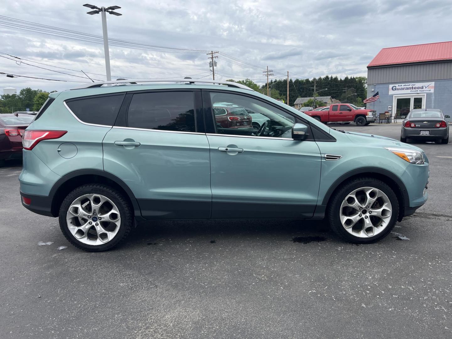 2013 Blue /Black Ford Escape Titanium 4WD (1FMCU9J99DU) with an 2.0L I4 DOHC 16V Turbo engine, 6-Speed Automatic transmission, located at 547 E. Main St., Orwell, OH, 44076, (440) 437-5893, 41.535435, -80.847855 - This 2013 Ford Escape is as loaded as an Escape can be. Powered by a 2.0 I4 Turbocharged EcoBoost engine and a 6 speed automatic transmission this Escape is quick yet fuel efficient. On the Inside you get a leather interior, power drivers seat W/ drivers memory functions, heated front seats and, a d - Photo#4