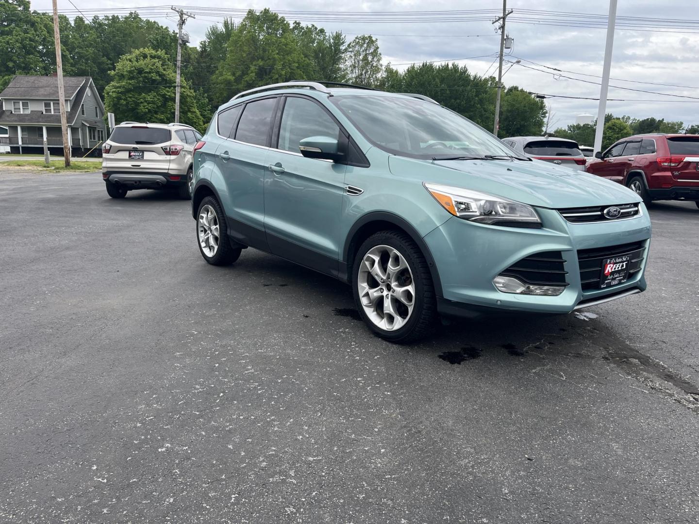 2013 Blue /Black Ford Escape Titanium 4WD (1FMCU9J99DU) with an 2.0L I4 DOHC 16V Turbo engine, 6-Speed Automatic transmission, located at 547 E. Main St., Orwell, OH, 44076, (440) 437-5893, 41.535435, -80.847855 - This 2013 Ford Escape is as loaded as an Escape can be. Powered by a 2.0 I4 Turbocharged EcoBoost engine and a 6 speed automatic transmission this Escape is quick yet fuel efficient. On the Inside you get a leather interior, power drivers seat W/ drivers memory functions, heated front seats and, a d - Photo#3