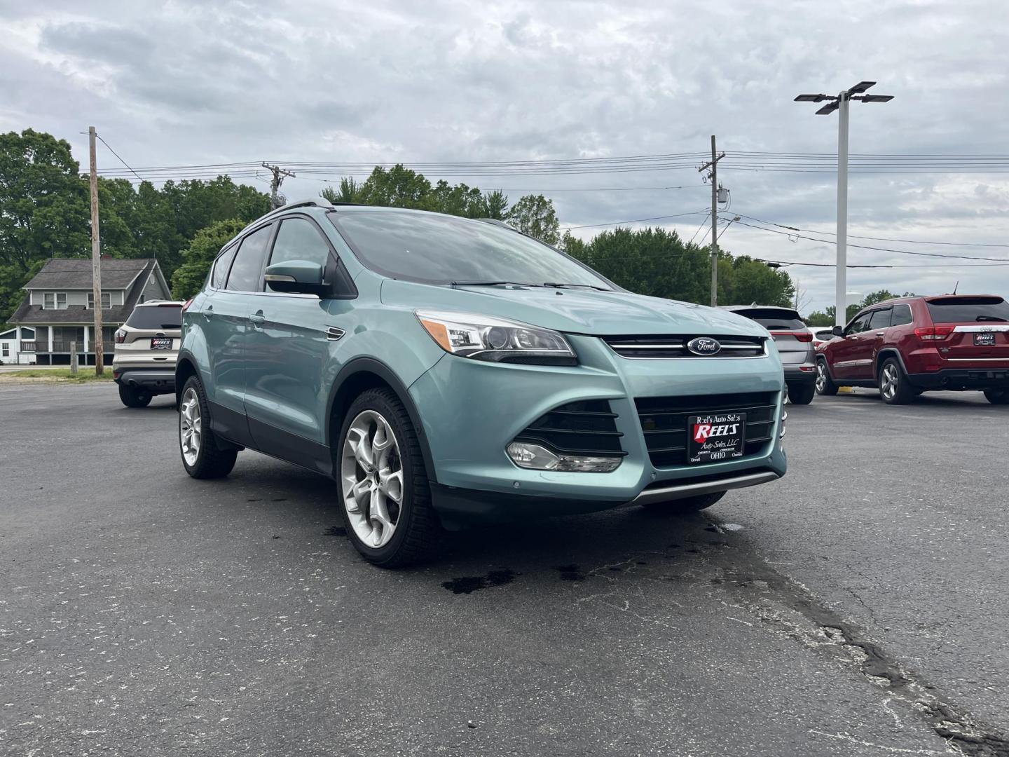 2013 Blue /Black Ford Escape Titanium 4WD (1FMCU9J99DU) with an 2.0L I4 DOHC 16V Turbo engine, 6-Speed Automatic transmission, located at 547 E. Main St., Orwell, OH, 44076, (440) 437-5893, 41.535435, -80.847855 - This 2013 Ford Escape is as loaded as an Escape can be. Powered by a 2.0 I4 Turbocharged EcoBoost engine and a 6 speed automatic transmission this Escape is quick yet fuel efficient. On the Inside you get a leather interior, power drivers seat W/ drivers memory functions, heated front seats and, a d - Photo#2