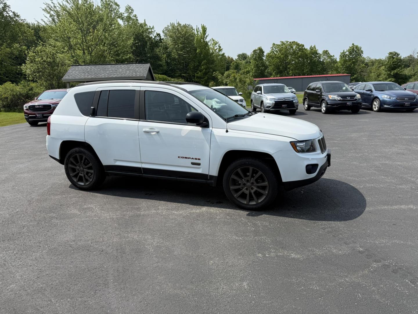 2016 White /Gray Jeep Compass Sport 75th Anniversary 4WD (1C4NJDBB9GD) with an 2.4L I4 DOHC 16V engine, 6-Speed Automatic transmission, located at 11115 Chardon Rd. , Chardon, OH, 44024, (440) 214-9705, 41.580246, -81.241943 - This 2016 Jeep Compass Sport 4WD 75th Edition is a compact go anywhere SUV. Powered by a 2.4 I4 engine and a 6 speed automatic transmission this little Jeep is respectable on gas while still being able to tackle any weather condition that is thrown it's way. This Jeep gives you added peace of mind w - Photo#3