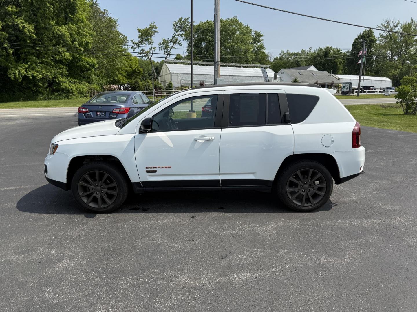 2016 White /Gray Jeep Compass Sport 75th Anniversary 4WD (1C4NJDBB9GD) with an 2.4L I4 DOHC 16V engine, 6-Speed Automatic transmission, located at 11115 Chardon Rd. , Chardon, OH, 44024, (440) 214-9705, 41.580246, -81.241943 - This 2016 Jeep Compass Sport 4WD 75th Edition is a compact go anywhere SUV. Powered by a 2.4 I4 engine and a 6 speed automatic transmission this little Jeep is respectable on gas while still being able to tackle any weather condition that is thrown it's way. This Jeep gives you added peace of mind w - Photo#13