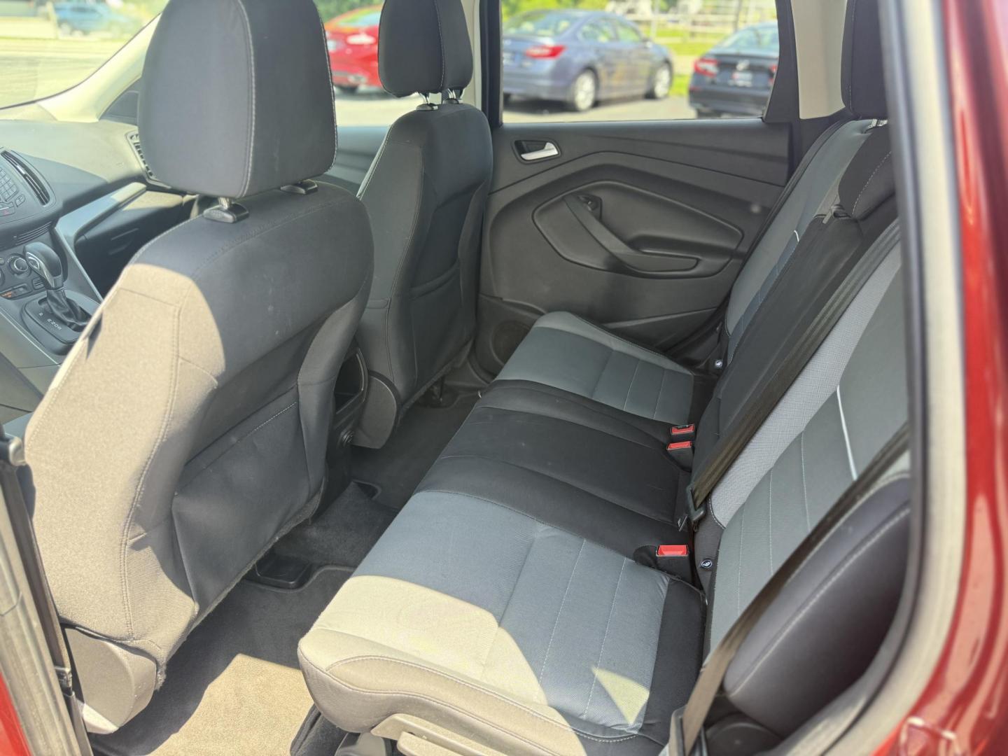 2015 Red /Black Ford Escape SE FWD (1FMCU0G75FU) with an 2.5L I4 DOHC 16V engine, 6-Speed Automatic transmission, located at 547 E. Main St., Orwell, OH, 44076, (440) 437-5893, 41.535435, -80.847855 - This 2015 Ford Escape SE FWD equipped with the 2.5L I4 Duratec engine offers impressive fuel efficiency, achieving around 30 MPG on the highway. It features a 6-speed automatic transmission, a power driver’s seat for comfort, and essential safety and convenience features including a backup camera, - Photo#23