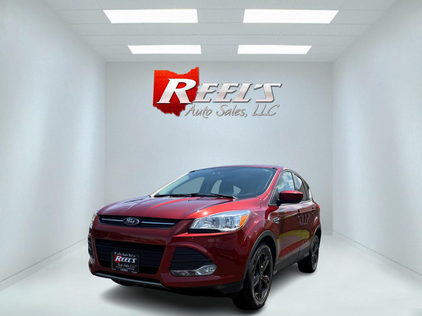 2015 Red /Black Ford Escape SE FWD (1FMCU0G75FU) with an 2.5L I4 DOHC 16V engine, 6-Speed Automatic transmission, located at 547 E. Main St., Orwell, OH, 44076, (440) 437-5893, 41.535435, -80.847855 - This 2015 Ford Escape SE FWD equipped with the 2.5L I4 Duratec engine offers impressive fuel efficiency, achieving around 30 MPG on the highway. It features a 6-speed automatic transmission, a power driver’s seat for comfort, and essential safety and convenience features including a backup camera, - Photo#0