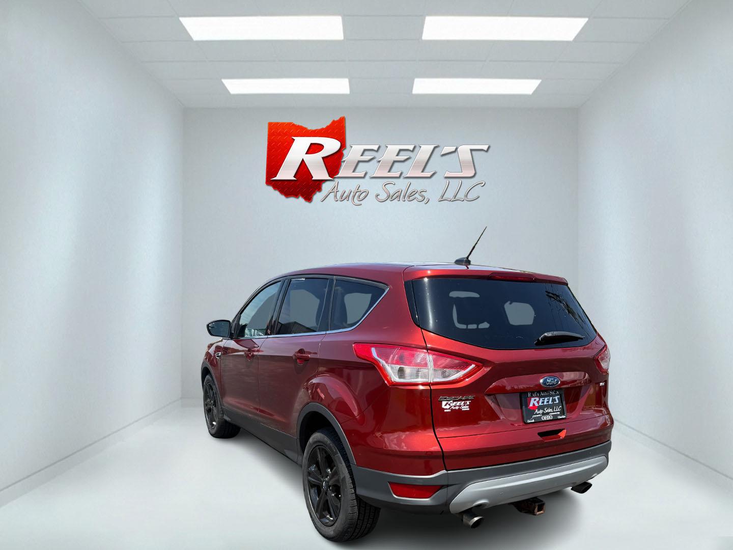 2015 Red /Black Ford Escape SE FWD (1FMCU0G75FU) with an 2.5L I4 DOHC 16V engine, 6-Speed Automatic transmission, located at 547 E. Main St., Orwell, OH, 44076, (440) 437-5893, 41.535435, -80.847855 - This 2015 Ford Escape SE FWD equipped with the 2.5L I4 Duratec engine offers impressive fuel efficiency, achieving around 30 MPG on the highway. It features a 6-speed automatic transmission, a power driver’s seat for comfort, and essential safety and convenience features including a backup camera, - Photo#38