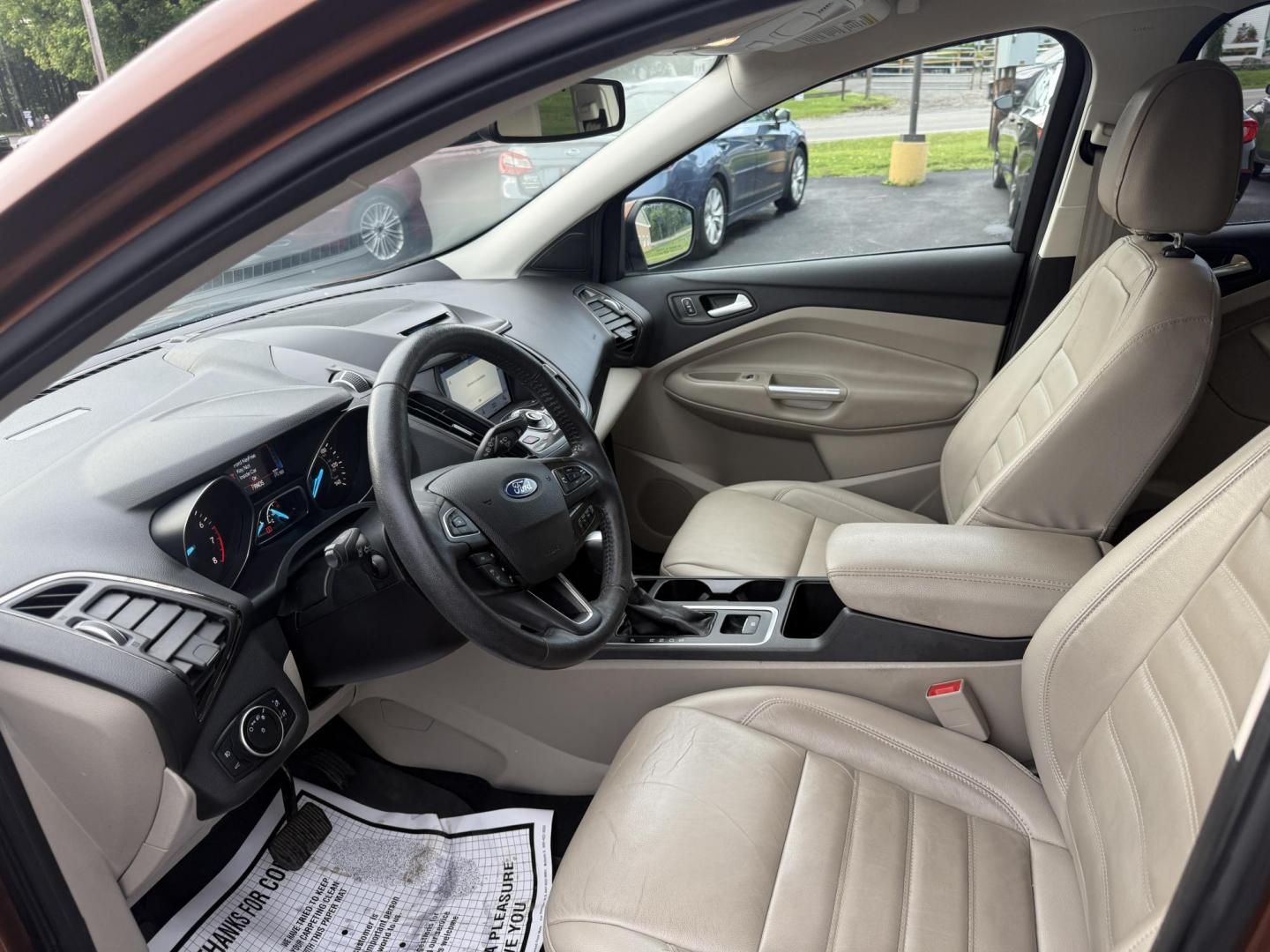 2017 Orange /Tan Ford Escape Titanium 4WD (1FMCU9JD2HU) with an 1.5L I4 DOHC 16V Turbo engine, 6A transmission, located at 11115 Chardon Rd. , Chardon, OH, 44024, (440) 214-9705, 41.580246, -81.241943 - This One Owner 2017 Ford Escape Titanium 4WD with the 1.5L Turbocharged EcoBoost I4 engine offers a combination of comfort, technology, and efficiency, achieving approximately 28 MPG on the highway. It features a luxurious leather interior, power and heated front seats, dual-zone automatic climate c - Photo#8