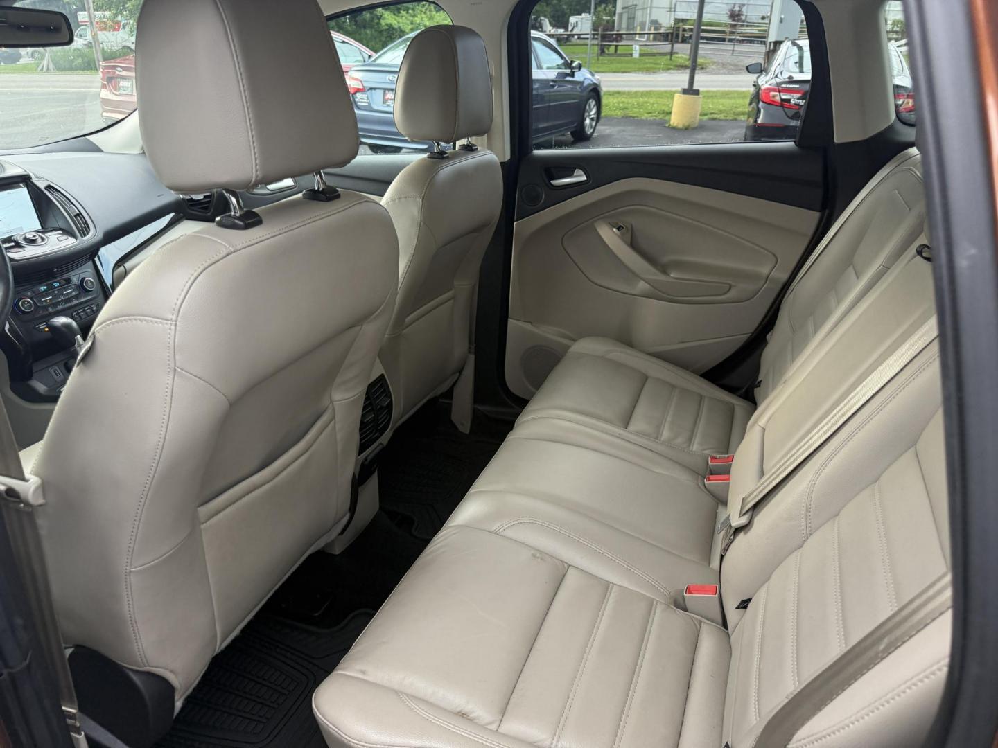 2017 Orange /Tan Ford Escape Titanium 4WD (1FMCU9JD2HU) with an 1.5L I4 DOHC 16V Turbo engine, 6A transmission, located at 11115 Chardon Rd. , Chardon, OH, 44024, (440) 214-9705, 41.580246, -81.241943 - This One Owner 2017 Ford Escape Titanium 4WD with the 1.5L Turbocharged EcoBoost I4 engine offers a combination of comfort, technology, and efficiency, achieving approximately 28 MPG on the highway. It features a luxurious leather interior, power and heated front seats, dual-zone automatic climate c - Photo#24