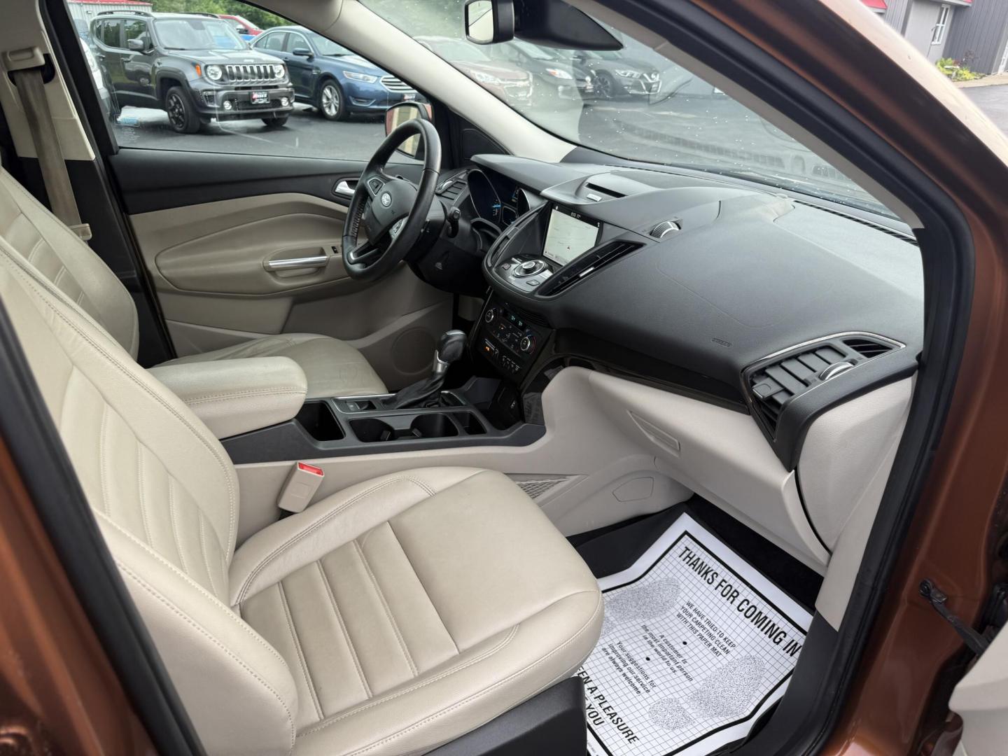 2017 Orange /Tan Ford Escape Titanium 4WD (1FMCU9JD2HU) with an 1.5L I4 DOHC 16V Turbo engine, 6A transmission, located at 11115 Chardon Rd. , Chardon, OH, 44024, (440) 214-9705, 41.580246, -81.241943 - This One Owner 2017 Ford Escape Titanium 4WD with the 1.5L Turbocharged EcoBoost I4 engine offers a combination of comfort, technology, and efficiency, achieving approximately 28 MPG on the highway. It features a luxurious leather interior, power and heated front seats, dual-zone automatic climate c - Photo#34