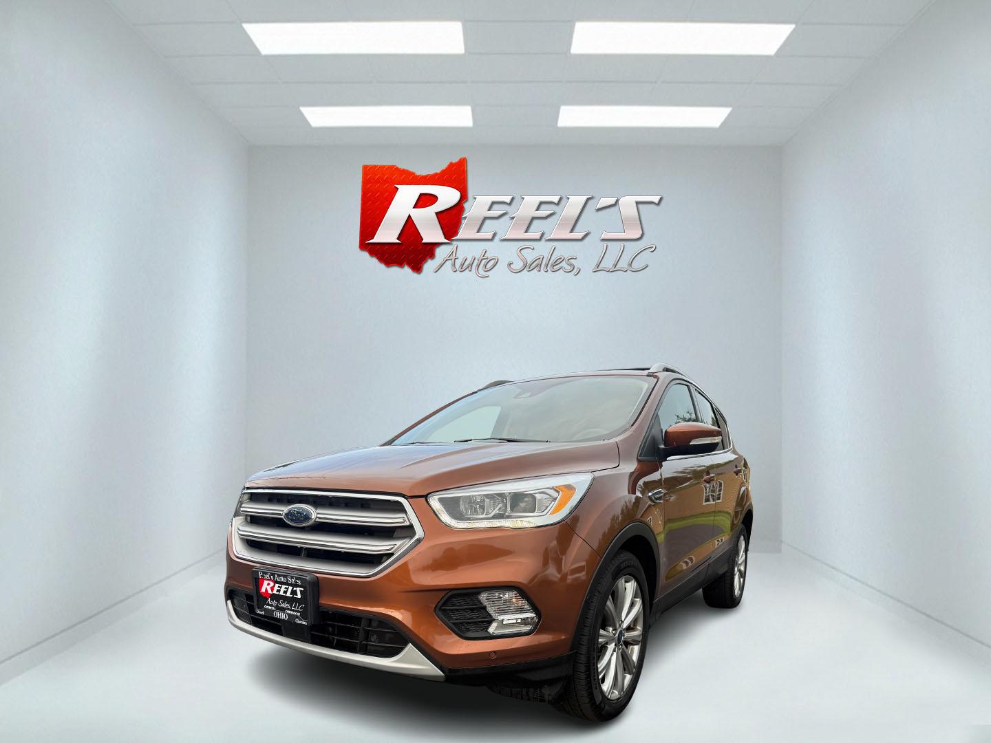 2017 Orange /Tan Ford Escape Titanium 4WD (1FMCU9JD2HU) with an 1.5L I4 DOHC 16V Turbo engine, 6A transmission, located at 11115 Chardon Rd. , Chardon, OH, 44024, (440) 214-9705, 41.580246, -81.241943 - This One Owner 2017 Ford Escape Titanium 4WD with the 1.5L Turbocharged EcoBoost I4 engine offers a combination of comfort, technology, and efficiency, achieving approximately 28 MPG on the highway. It features a luxurious leather interior, power and heated front seats, dual-zone automatic climate c - Photo#0