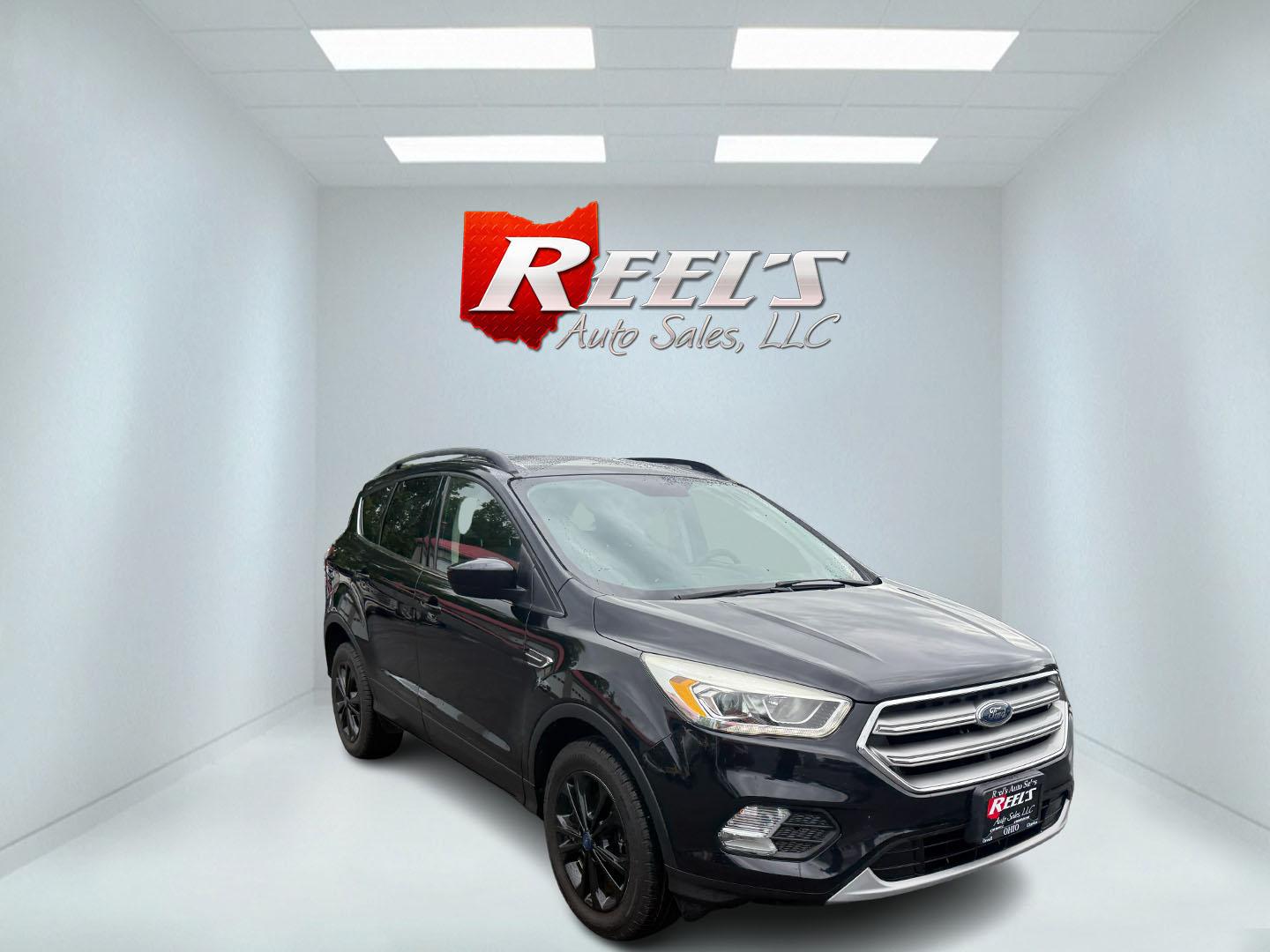 2017 Black /Gray Ford Escape SE 4WD (1FMCU9GDXHU) with an 1.5L I4 DOHC 16V Turbo engine, 6A transmission, located at 547 E. Main St., Orwell, OH, 44076, (440) 437-5893, 41.535435, -80.847855 - This 2017 Ford Escape SE 4WD with the 1.5L Turbocharged EcoBoost I4 engine combines efficiency and convenience, delivering approximately 28 MPG on the highway. It features a 6-speed automatic transmission, a power driver’s seat, and advanced safety with blind spot monitoring. The SUV is equipped w - Photo#2