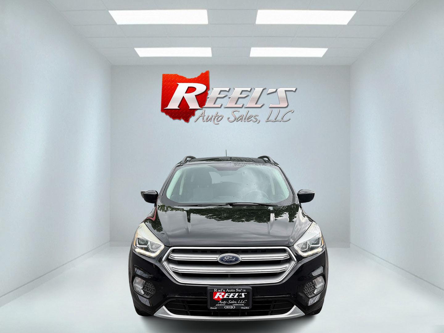 2017 Black /Gray Ford Escape SE 4WD (1FMCU9GDXHU) with an 1.5L I4 DOHC 16V Turbo engine, 6A transmission, located at 547 E. Main St., Orwell, OH, 44076, (440) 437-5893, 41.535435, -80.847855 - This 2017 Ford Escape SE 4WD with the 1.5L Turbocharged EcoBoost I4 engine combines efficiency and convenience, delivering approximately 28 MPG on the highway. It features a 6-speed automatic transmission, a power driver’s seat, and advanced safety with blind spot monitoring. The SUV is equipped w - Photo#1