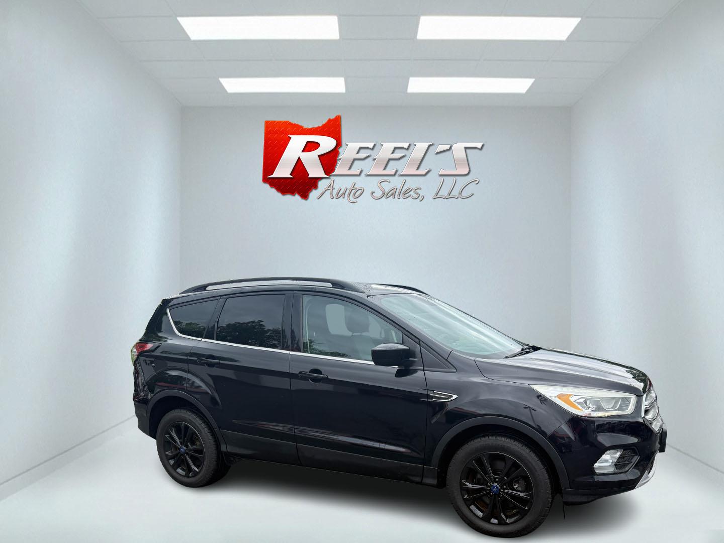 2017 Black /Gray Ford Escape SE 4WD (1FMCU9GDXHU) with an 1.5L I4 DOHC 16V Turbo engine, 6A transmission, located at 547 E. Main St., Orwell, OH, 44076, (440) 437-5893, 41.535435, -80.847855 - This 2017 Ford Escape SE 4WD with the 1.5L Turbocharged EcoBoost I4 engine combines efficiency and convenience, delivering approximately 28 MPG on the highway. It features a 6-speed automatic transmission, a power driver’s seat, and advanced safety with blind spot monitoring. The SUV is equipped w - Photo#32