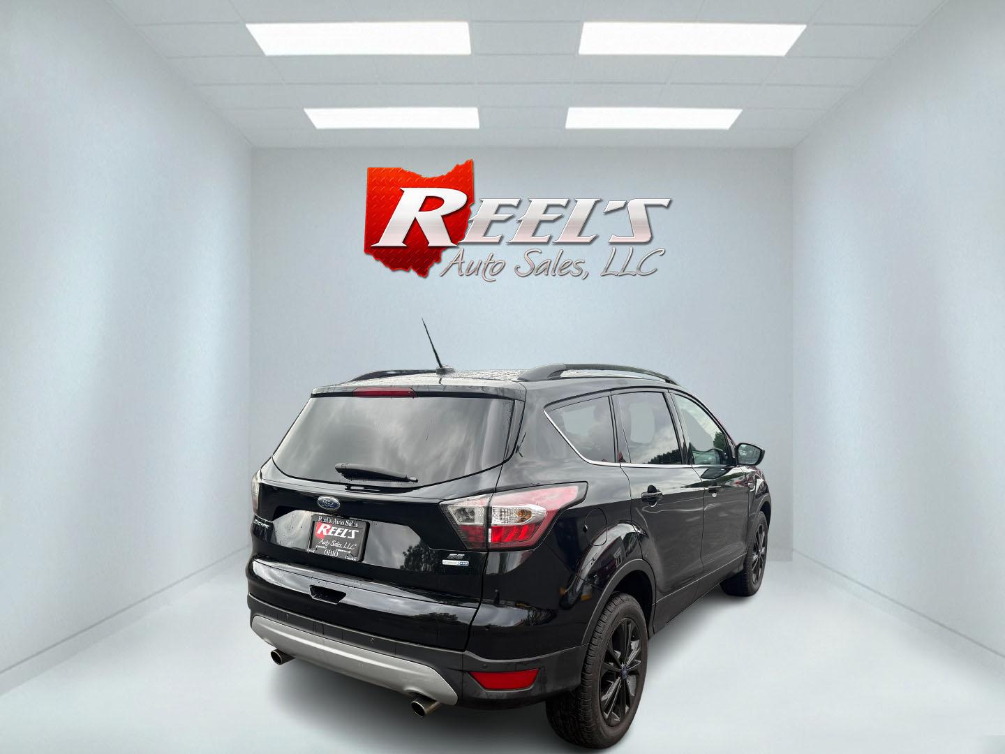 2017 Black /Gray Ford Escape SE 4WD (1FMCU9GDXHU) with an 1.5L I4 DOHC 16V Turbo engine, 6A transmission, located at 547 E. Main St., Orwell, OH, 44076, (440) 437-5893, 41.535435, -80.847855 - This 2017 Ford Escape SE 4WD with the 1.5L Turbocharged EcoBoost I4 engine combines efficiency and convenience, delivering approximately 28 MPG on the highway. It features a 6-speed automatic transmission, a power driver’s seat, and advanced safety with blind spot monitoring. The SUV is equipped w - Photo#34