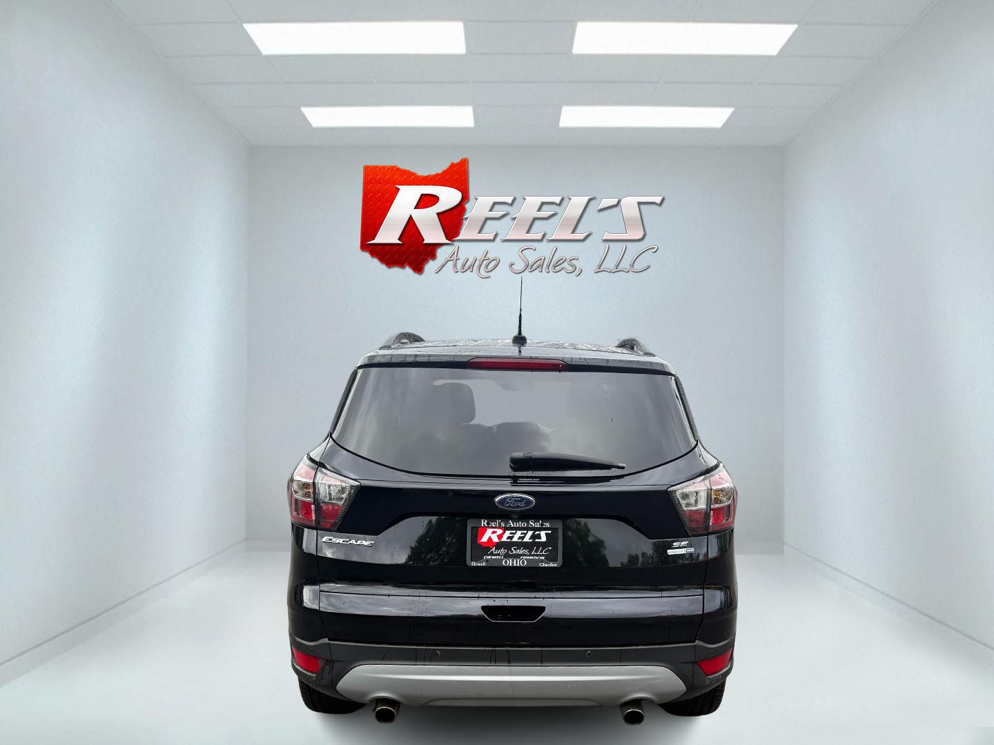 2017 Black /Gray Ford Escape SE 4WD (1FMCU9GDXHU) with an 1.5L I4 DOHC 16V Turbo engine, 6A transmission, located at 547 E. Main St., Orwell, OH, 44076, (440) 437-5893, 41.535435, -80.847855 - This 2017 Ford Escape SE 4WD with the 1.5L Turbocharged EcoBoost I4 engine combines efficiency and convenience, delivering approximately 28 MPG on the highway. It features a 6-speed automatic transmission, a power driver’s seat, and advanced safety with blind spot monitoring. The SUV is equipped w - Photo#35