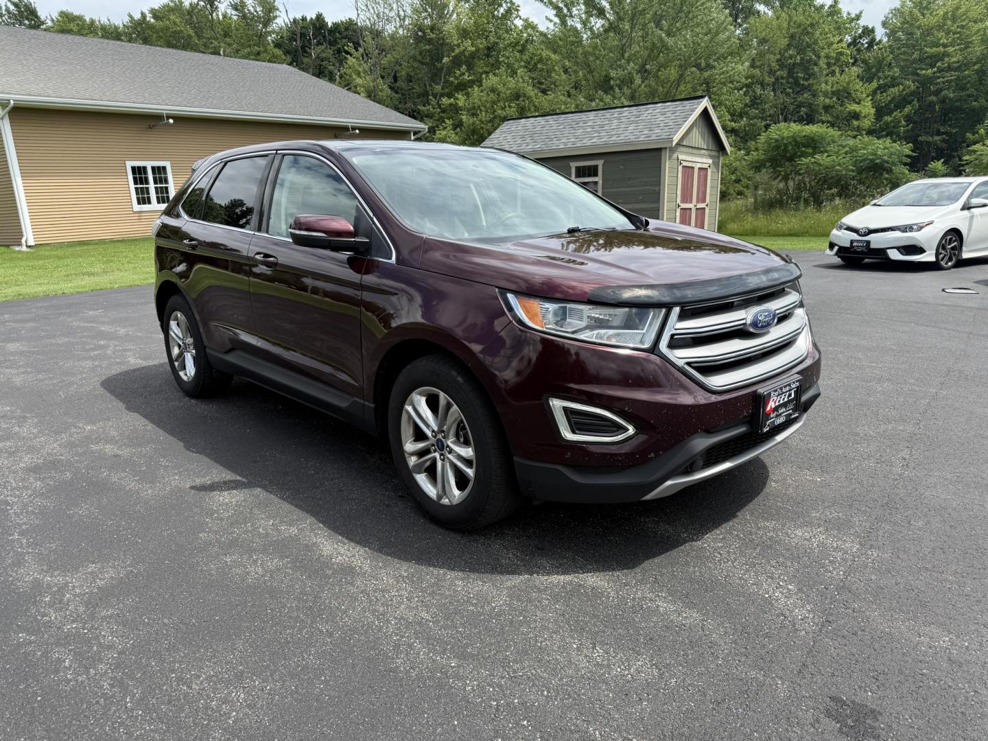 2017 Burgundy /Black Ford Edge SEL AWD (2FMPK4J99HB) with an 2.0L L4 DOHC 16V engine, 6A transmission, located at 11115 Chardon Rd. , Chardon, OH, 44024, (440) 214-9705, 41.580246, -81.241943 - This 2017 Ford Edge SEL AWD is a midsize SUV featuring a turbocharged 2.0L EcoBoost I4 engine and a 6-speed automatic transmission, achieving up to 27 MPG on the highway. It offers a premium leather interior with heated front seats, a power panoramic moonroof, an 8-inch touchscreen with navigation, - Photo#2