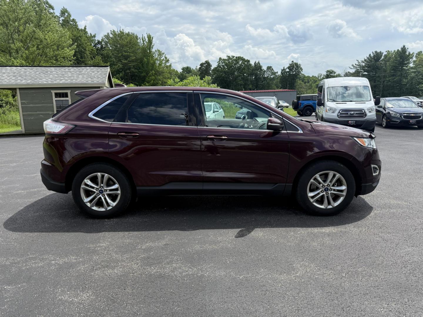 2017 Burgundy /Black Ford Edge SEL AWD (2FMPK4J99HB) with an 2.0L L4 DOHC 16V engine, 6A transmission, located at 11115 Chardon Rd. , Chardon, OH, 44024, (440) 214-9705, 41.580246, -81.241943 - This 2017 Ford Edge SEL AWD is a midsize SUV featuring a turbocharged 2.0L EcoBoost I4 engine and a 6-speed automatic transmission, achieving up to 27 MPG on the highway. It offers a premium leather interior with heated front seats, a power panoramic moonroof, an 8-inch touchscreen with navigation, - Photo#5