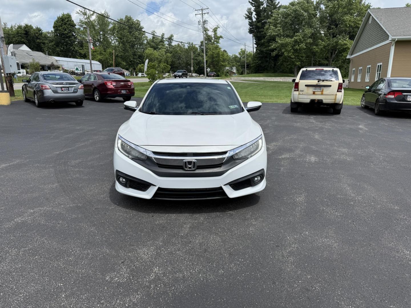 2017 White /Gray Honda Civic Touring Coupe CVT (2HGFC3B99HH) with an 1.5L I4 DOHC 16V Turbo engine, Automatic transmission, located at 11115 Chardon Rd. , Chardon, OH, 44024, (440) 214-9705, 41.580246, -81.241943 - FRESH TRADE ALERT ---- This 2017 Honda Civic Touring Coupe features a turbocharged 1.5L I4 engine, achieving an impressive 40 MPG highway, and comes equipped with a leather interior, heated front seats, dual-zone automatic climate control, and a 7-inch touchscreen supporting Apple CarPlay and Androi - Photo#1