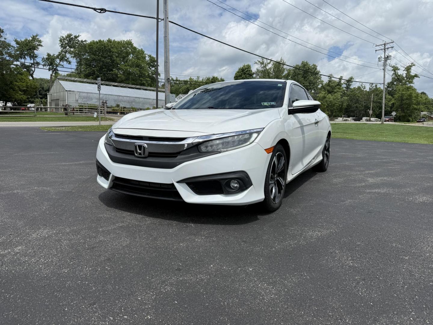 2017 White /Gray Honda Civic Touring Coupe CVT (2HGFC3B99HH) with an 1.5L I4 DOHC 16V Turbo engine, Automatic transmission, located at 11115 Chardon Rd. , Chardon, OH, 44024, (440) 214-9705, 41.580246, -81.241943 - FRESH TRADE ALERT ---- This 2017 Honda Civic Touring Coupe features a turbocharged 1.5L I4 engine, achieving an impressive 40 MPG highway, and comes equipped with a leather interior, heated front seats, dual-zone automatic climate control, and a 7-inch touchscreen supporting Apple CarPlay and Androi - Photo#0