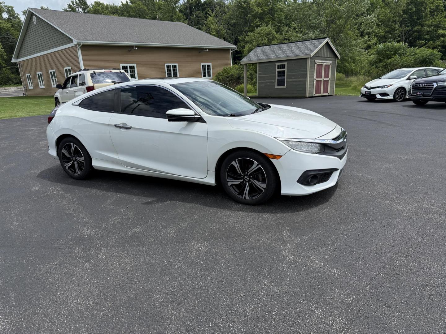 2017 White /Gray Honda Civic Touring Coupe CVT (2HGFC3B99HH) with an 1.5L I4 DOHC 16V Turbo engine, Automatic transmission, located at 11115 Chardon Rd. , Chardon, OH, 44024, (440) 214-9705, 41.580246, -81.241943 - FRESH TRADE ALERT ---- This 2017 Honda Civic Touring Coupe features a turbocharged 1.5L I4 engine, achieving an impressive 40 MPG highway, and comes equipped with a leather interior, heated front seats, dual-zone automatic climate control, and a 7-inch touchscreen supporting Apple CarPlay and Androi - Photo#3