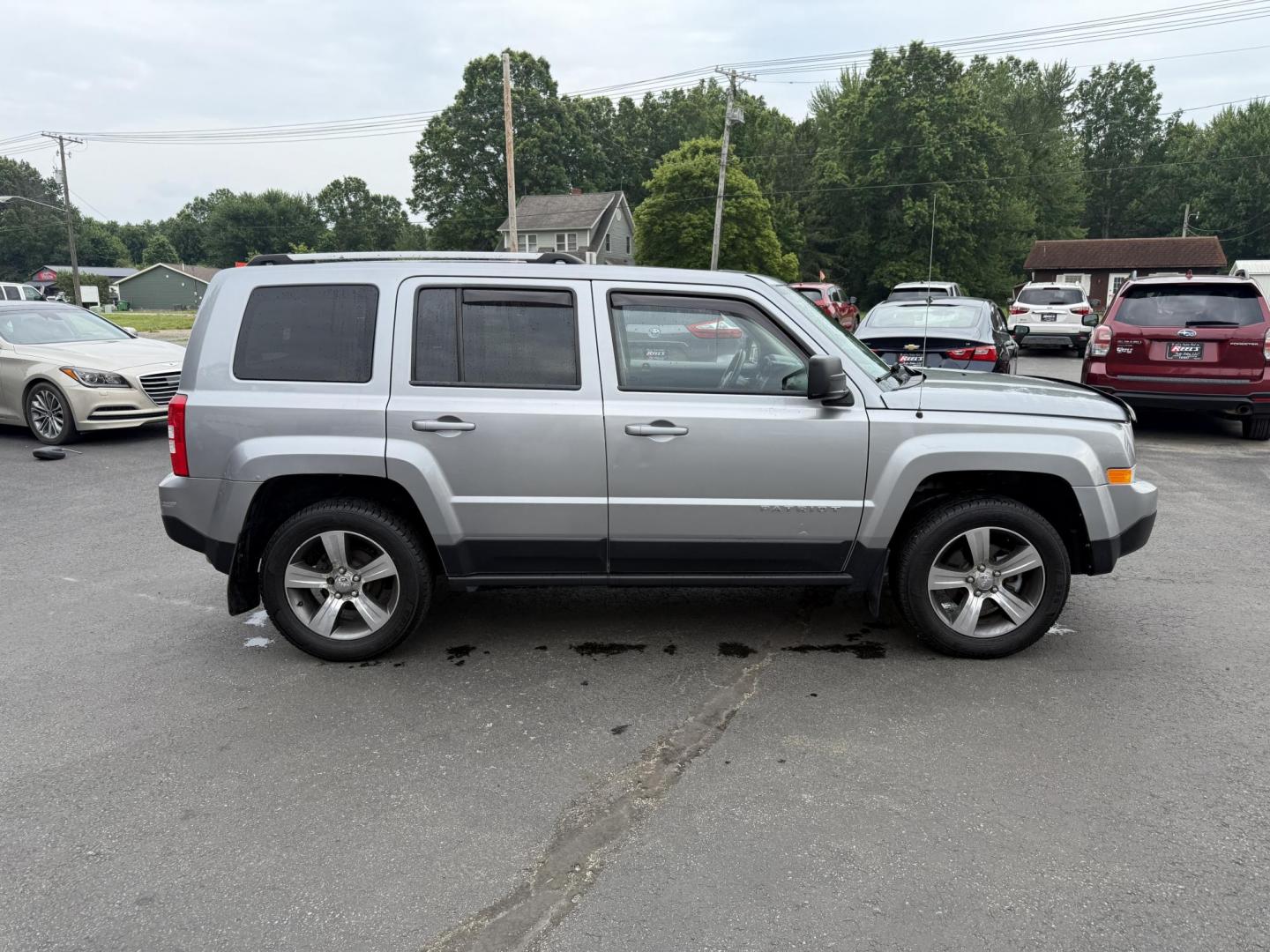 2017 Silver /Black Jeep Patriot High Altitude 4WD (1C4NJRFB3HD) with an 2.4L I4 DOHC 16V engine, 6 Speed Automatic transmission, located at 547 E. Main St., Orwell, OH, 44076, (440) 437-5893, 41.535435, -80.847855 - This 2017 Jeep Patriot High Altitude 4WD is a compact SUV featuring a 2.4L I4 engine paired with a 6-speed automatic transmission, offering capable all-wheel-drive performance. It boasts a leather interior, power driver's seat, heated front seats, remote start, and a 6.5" touchscreen with a backup c - Photo#5