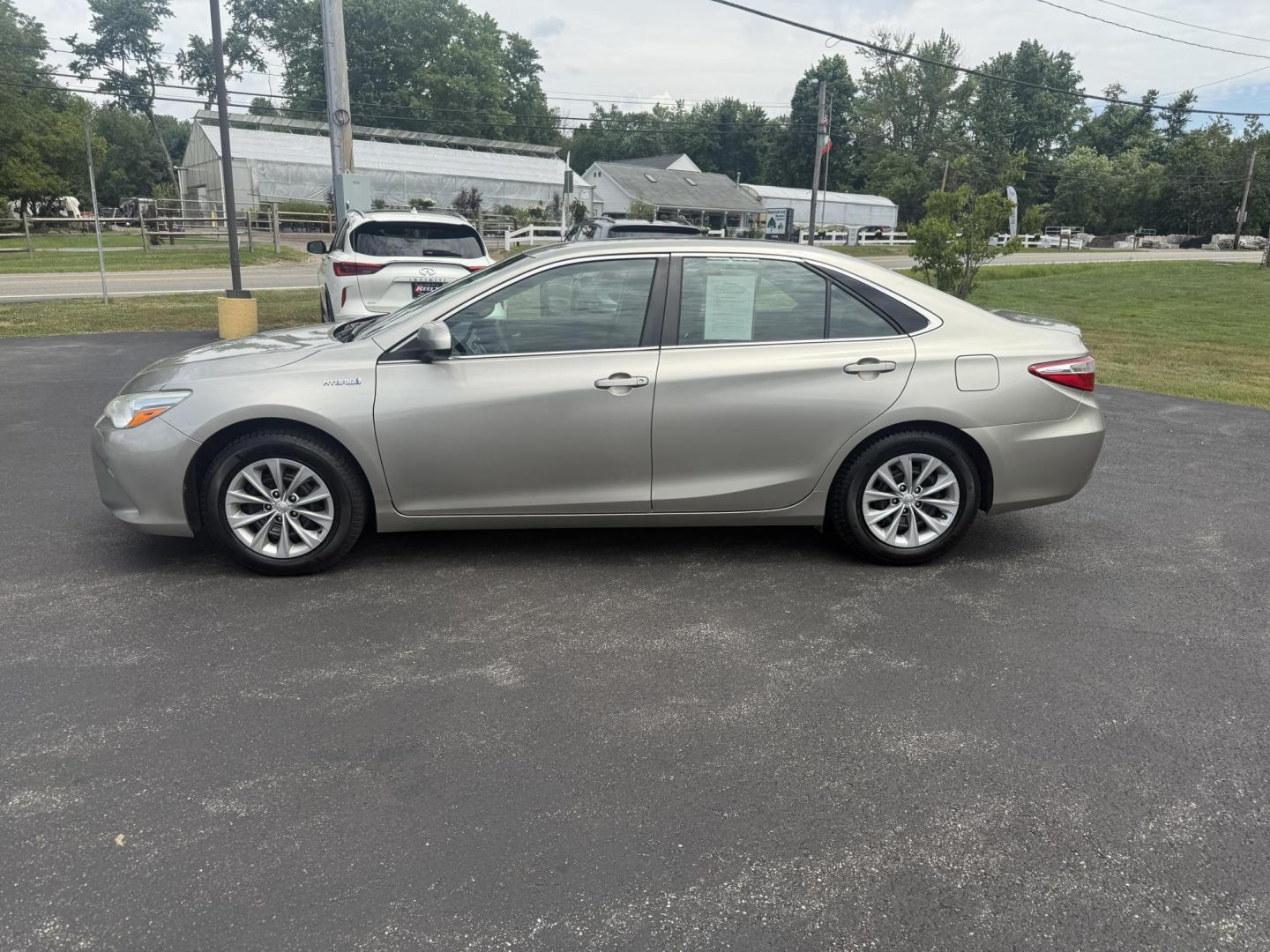 2015 Gold /Black Toyota Camry Hybrid LE (4T1BD1FK0FU) with an 2.5L I4 DOHC 16V HYBRID engine, Automatic transmission, located at 11115 Chardon Rd. , Chardon, OH, 44024, (440) 214-9705, 41.580246, -81.241943 - This 2015 Toyota Camry LE Hybrid is a fuel-efficient midsize sedan offering an impressive 40 MPG combined and a net power output of 200 horsepower. It features practical amenities like dusk-sensing headlights, dual-zone automatic climate control, an 8-way power driver’s seat, a 6.1-inch touchscree - Photo#12