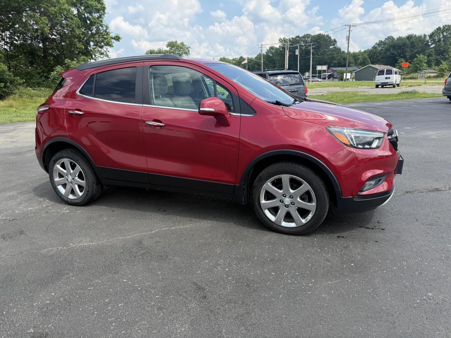 2017 Red /Tan Buick Encore Essence AWD (KL4CJGSBXHB) with an 1.4L I4 DOHC 16V TURBO engine, 6A transmission, located at 547 E. Main St., Orwell, OH, 44076, (440) 437-5893, 41.535435, -80.847855 - This 2017 Buick Encore Essence AWD is a stylish and versatile compact SUV featuring a 1.4-liter turbocharged I4 EcoTec engine paired with a smooth 6-speed automatic transmission, offering a commendable 31 MPG on the highway. Its luxurious leather interior, power driver’s seat, and an 8.0-inch touc - Photo#3