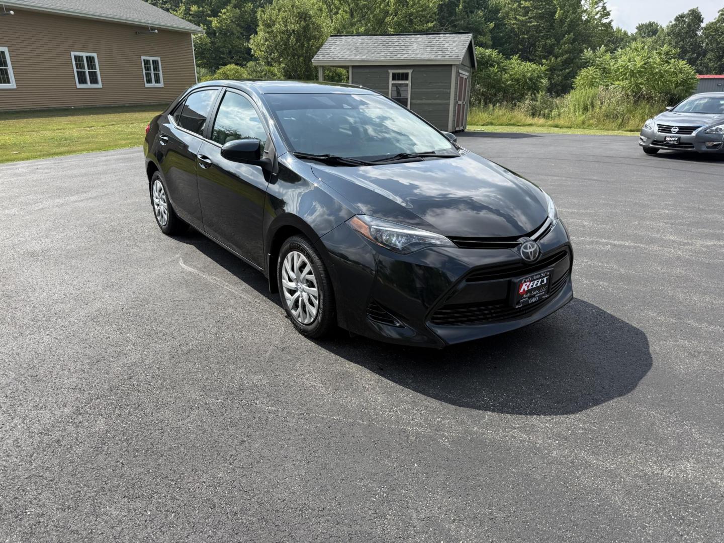 2017 Black /Gray Toyota Corolla LE CVT (2T1BURHE5HC) with an 1.8L I4 DOHC 16V engine, Automatic transmission, located at 11115 Chardon Rd. , Chardon, OH, 44024, (440) 214-9705, 41.580246, -81.241943 - This 2017 Toyota Corolla LE offers a reliable and efficient drive with its 1.8L I4 engine, achieving up to 36 MPG on the highway. Key features include advanced safety tech like lane departure warning, forward collision warning, and adaptive cruise control, as well as eight standard airbags and a bac - Photo#2