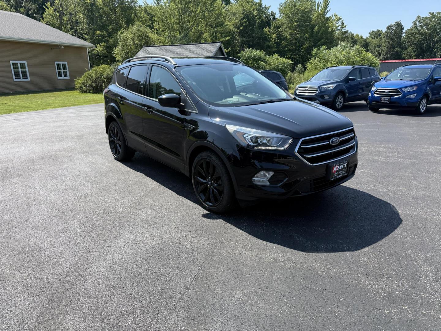 2018 Black /Black Ford Escape SE 4WD (1FMCU9GD6JU) with an 1.5L I4 DOHC 16V Turbo engine, 6A transmission, located at 547 E. Main St., Orwell, OH, 44076, (440) 437-5893, 41.535435, -80.847855 - This 2018 Ford Escape SE 4WD features a 1.5L turbocharged EcoBoost I4 engine paired with a 6-speed automatic transmission, delivering a good balance of power and efficiency (up to 28 MPG highway). It offers comfort and convenience with a power driver’s seat, heated front seats, dual-zone automatic - Photo#2