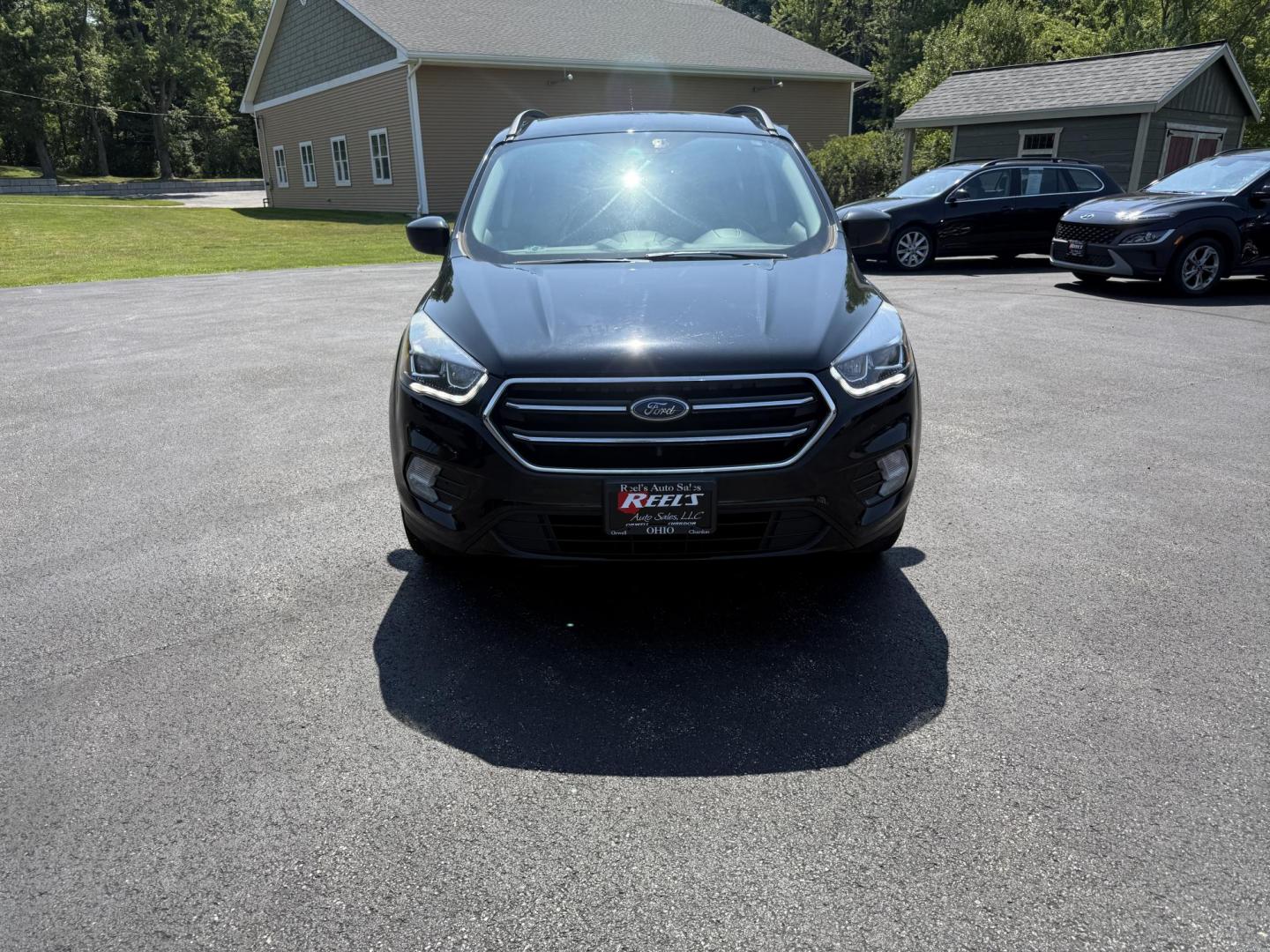 2018 Black /Black Ford Escape SE 4WD (1FMCU9GD6JU) with an 1.5L I4 DOHC 16V Turbo engine, 6A transmission, located at 547 E. Main St., Orwell, OH, 44076, (440) 437-5893, 41.535435, -80.847855 - This 2018 Ford Escape SE 4WD features a 1.5L turbocharged EcoBoost I4 engine paired with a 6-speed automatic transmission, delivering a good balance of power and efficiency (up to 28 MPG highway). It offers comfort and convenience with a power driver’s seat, heated front seats, dual-zone automatic - Photo#1