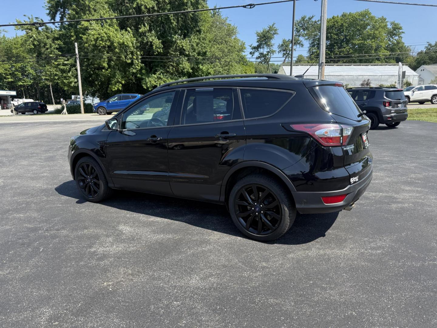 2018 Black /Black Ford Escape SE 4WD (1FMCU9GD6JU) with an 1.5L I4 DOHC 16V Turbo engine, 6A transmission, located at 547 E. Main St., Orwell, OH, 44076, (440) 437-5893, 41.535435, -80.847855 - This 2018 Ford Escape SE 4WD features a 1.5L turbocharged EcoBoost I4 engine paired with a 6-speed automatic transmission, delivering a good balance of power and efficiency (up to 28 MPG highway). It offers comfort and convenience with a power driver’s seat, heated front seats, dual-zone automatic - Photo#10
