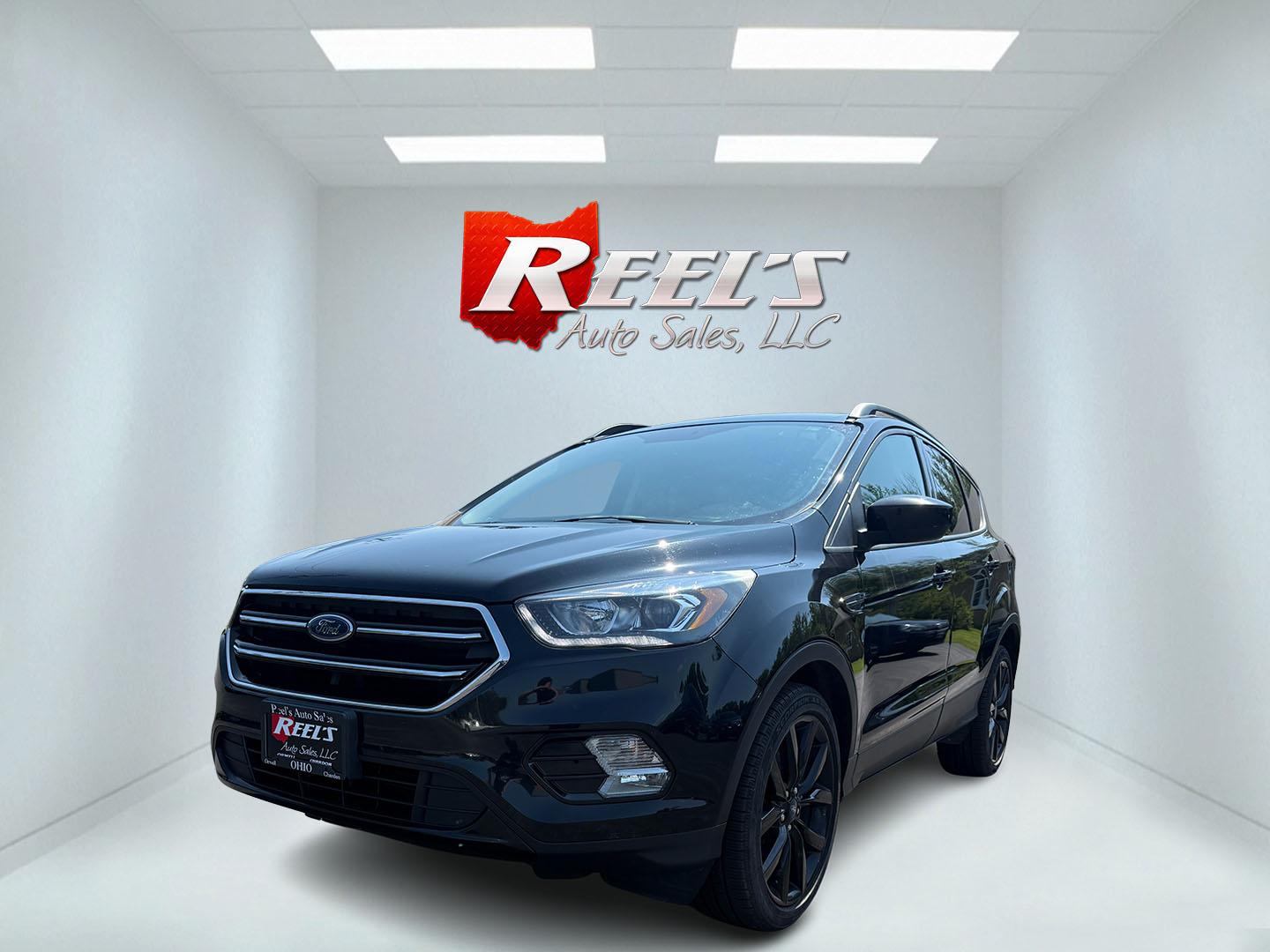 2018 Black /Black Ford Escape SE 4WD (1FMCU9GD6JU) with an 1.5L I4 DOHC 16V Turbo engine, Automatic transmission, located at 547 E. Main St., Orwell, OH, 44076, (440) 437-5893, 41.535435, -80.847855 - 2018 Ford Escape SE 4WD – Sporty Style, Turbocharged Performance, All-Season Confidence Upgrade your drive with this 2018 Ford Escape SE 4WD—an SUV that combines sporty design, smart technology, and practical versatility. Under the hood, you’ll find a turbocharged 1.5L EcoBoost engine paire - Photo#0