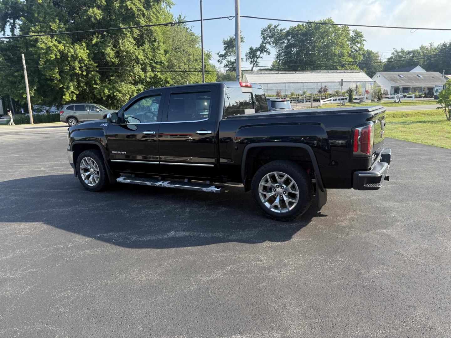 2016 Black /Black GMC Sierra 1500 SLT Crew Cab Long Box 4WD (3GTU2NEC2GG) with an 5.3L V8 OHV 16V engine, 6A transmission, located at 11115 Chardon Rd. , Chardon, OH, 44024, (440) 214-9705, 41.580246, -81.241943 - This One Owner 2016 GMC Sierra 1500 SLT Crew Cab 4WD is equipped with a 5.3L EcoTec3 V8 engine and a 6-speed automatic transmission, delivering a strong 9,100-pound towing capacity thanks to its 3.42 gearing. This model features a refined leather interior with heated front seats, an 8.0" touchscreen - Photo#12