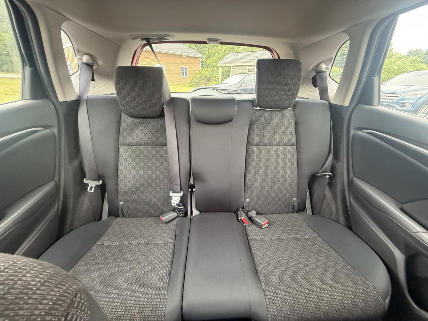 2016 Red /Black Honda Fit LX CVT (JHMGK5H55GX) with an 1.5L I4 SOHC 16V engine, Automatic transmission, located at 11115 Chardon Rd. , Chardon, OH, 44024, (440) 214-9705, 41.580246, -81.241943 - This One Owner 2016 Honda Fit LX is a practical and efficient subcompact hatchback powered by a 1.5L inline-4 engine, delivering impressive fuel economy of up to 40 MPG on the highway. It features a 5.0" center screen, backup camera, daytime running lights, ECO mode for enhanced efficiency, and spor - Photo#24