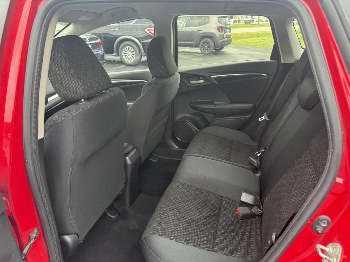 2016 Red /Black Honda Fit LX CVT (JHMGK5H55GX) with an 1.5L I4 SOHC 16V engine, Automatic transmission, located at 11115 Chardon Rd. , Chardon, OH, 44024, (440) 214-9705, 41.580246, -81.241943 - This One Owner 2016 Honda Fit LX is a practical and efficient subcompact hatchback powered by a 1.5L inline-4 engine, delivering impressive fuel economy of up to 40 MPG on the highway. It features a 5.0" center screen, backup camera, daytime running lights, ECO mode for enhanced efficiency, and spor - Photo#25