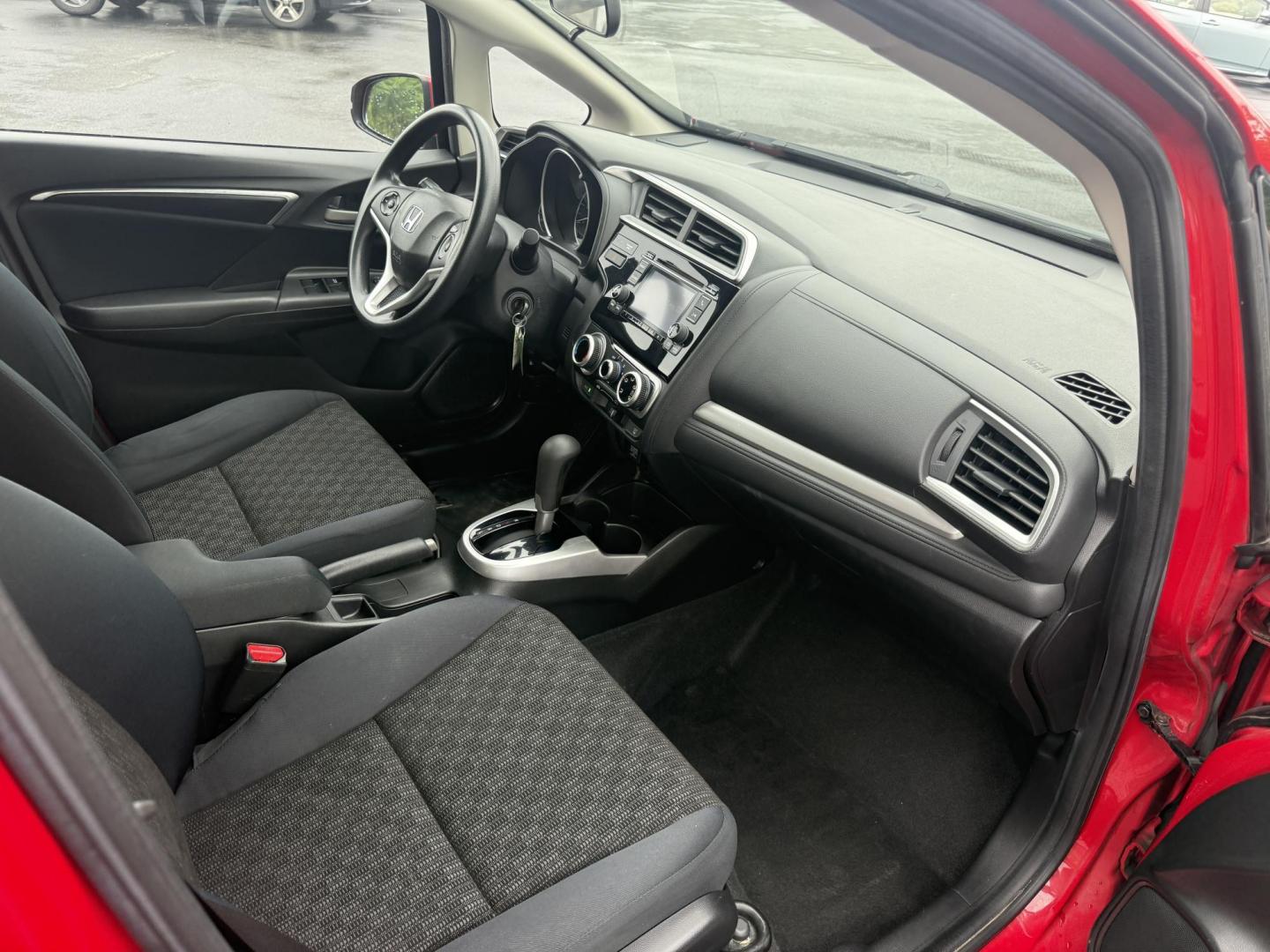 2016 Red /Black Honda Fit LX CVT (JHMGK5H55GX) with an 1.5L I4 SOHC 16V engine, Automatic transmission, located at 11115 Chardon Rd. , Chardon, OH, 44024, (440) 214-9705, 41.580246, -81.241943 - This One Owner 2016 Honda Fit LX is a practical and efficient subcompact hatchback powered by a 1.5L inline-4 engine, delivering impressive fuel economy of up to 40 MPG on the highway. It features a 5.0" center screen, backup camera, daytime running lights, ECO mode for enhanced efficiency, and spor - Photo#32