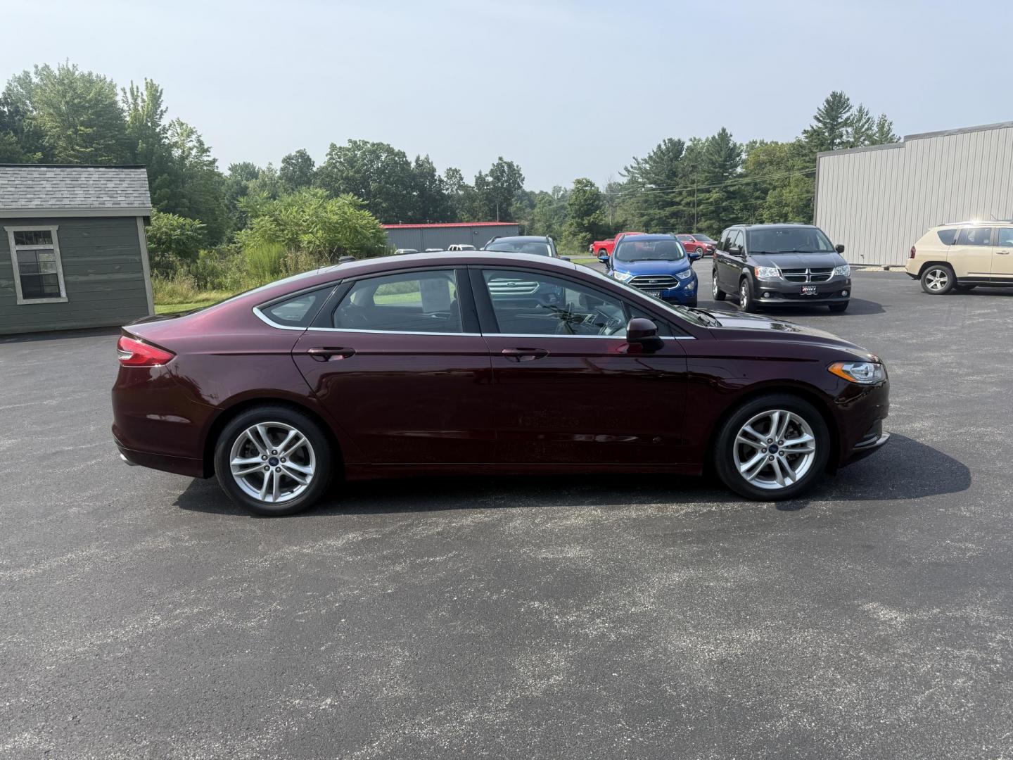 2018 Burgundy /Black Ford Fusion SE (3FA6P0HD7JR) with an 1.5L I4 DOHC 16V Turbo engine, 6A transmission, located at 11115 Chardon Rd. , Chardon, OH, 44024, (440) 214-9705, 41.580246, -81.241943 - This One Owner 2018 Ford Fusion SE FWD is powered by a 1.5L turbocharged EcoBoost I4 engine paired with a 6-speed automatic transmission, delivering up to 34 MPG on the highway. It features an 8.0-inch center touchscreen with Apple CarPlay and Android Auto, dual zone automatic climate control, power - Photo#5