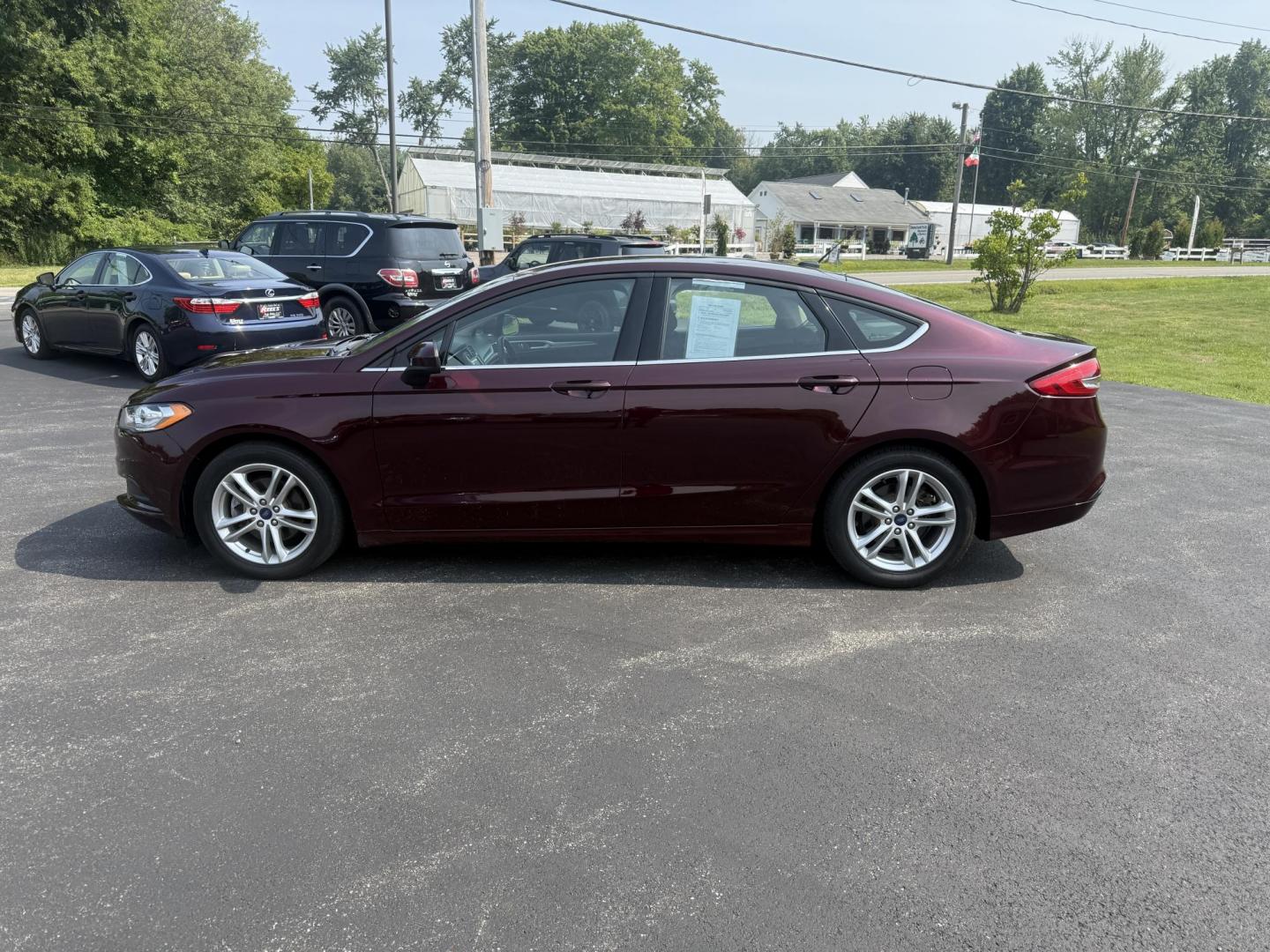 2018 Burgundy /Black Ford Fusion SE (3FA6P0HD7JR) with an 1.5L I4 DOHC 16V Turbo engine, 6A transmission, located at 11115 Chardon Rd. , Chardon, OH, 44024, (440) 214-9705, 41.580246, -81.241943 - This One Owner 2018 Ford Fusion SE FWD is powered by a 1.5L turbocharged EcoBoost I4 engine paired with a 6-speed automatic transmission, delivering up to 34 MPG on the highway. It features an 8.0-inch center touchscreen with Apple CarPlay and Android Auto, dual zone automatic climate control, power - Photo#12