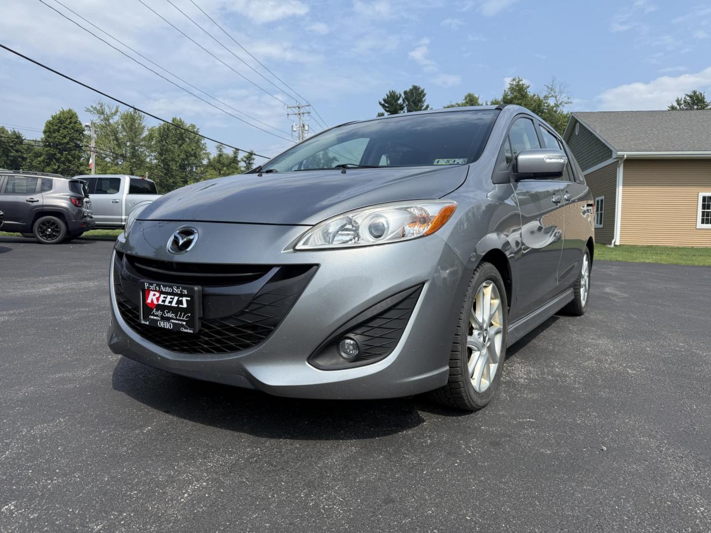 2015 Silver /Black Mazda MAZDA5 Grand Touring (JM1CW2DL0F0) with an 2.5L I4 DOHC 16V engine, 5-Speed Automatic transmission, located at 11115 Chardon Rd. , Chardon, OH, 44024, (440) 214-9705, 41.580246, -81.241943 - This 2015 Mazda Mazda 5 with a 2.5L I4 engine and 5-speed automatic transmission offers a versatile and comfortable minivan, achieving approximately 29 MPG highway. It features a leather interior, second-row captain’s seats, heated front seats, automatic climate control, a power moonroof, dusk-sen - Photo#0