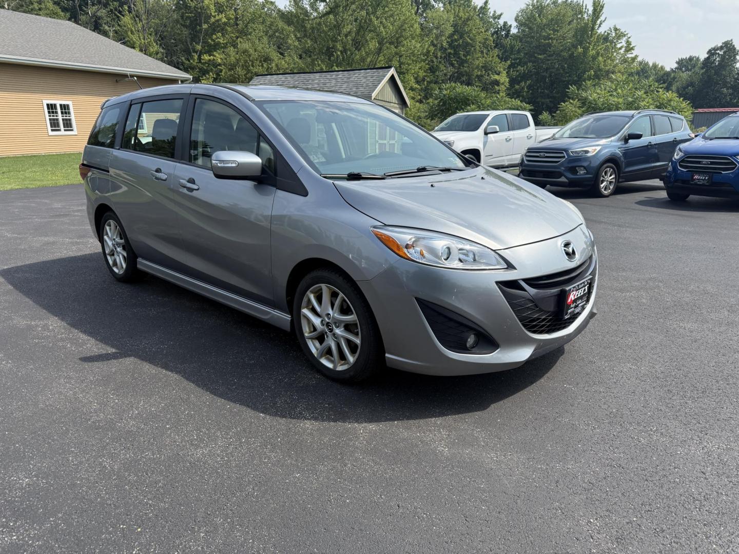 2015 Silver /Black Mazda MAZDA5 Grand Touring (JM1CW2DL0F0) with an 2.5L I4 DOHC 16V engine, 5-Speed Automatic transmission, located at 11115 Chardon Rd. , Chardon, OH, 44024, (440) 214-9705, 41.580246, -81.241943 - This 2015 Mazda Mazda 5 with a 2.5L I4 engine and 5-speed automatic transmission offers a versatile and comfortable minivan, achieving approximately 29 MPG highway. It features a leather interior, second-row captain’s seats, heated front seats, automatic climate control, a power moonroof, dusk-sen - Photo#2